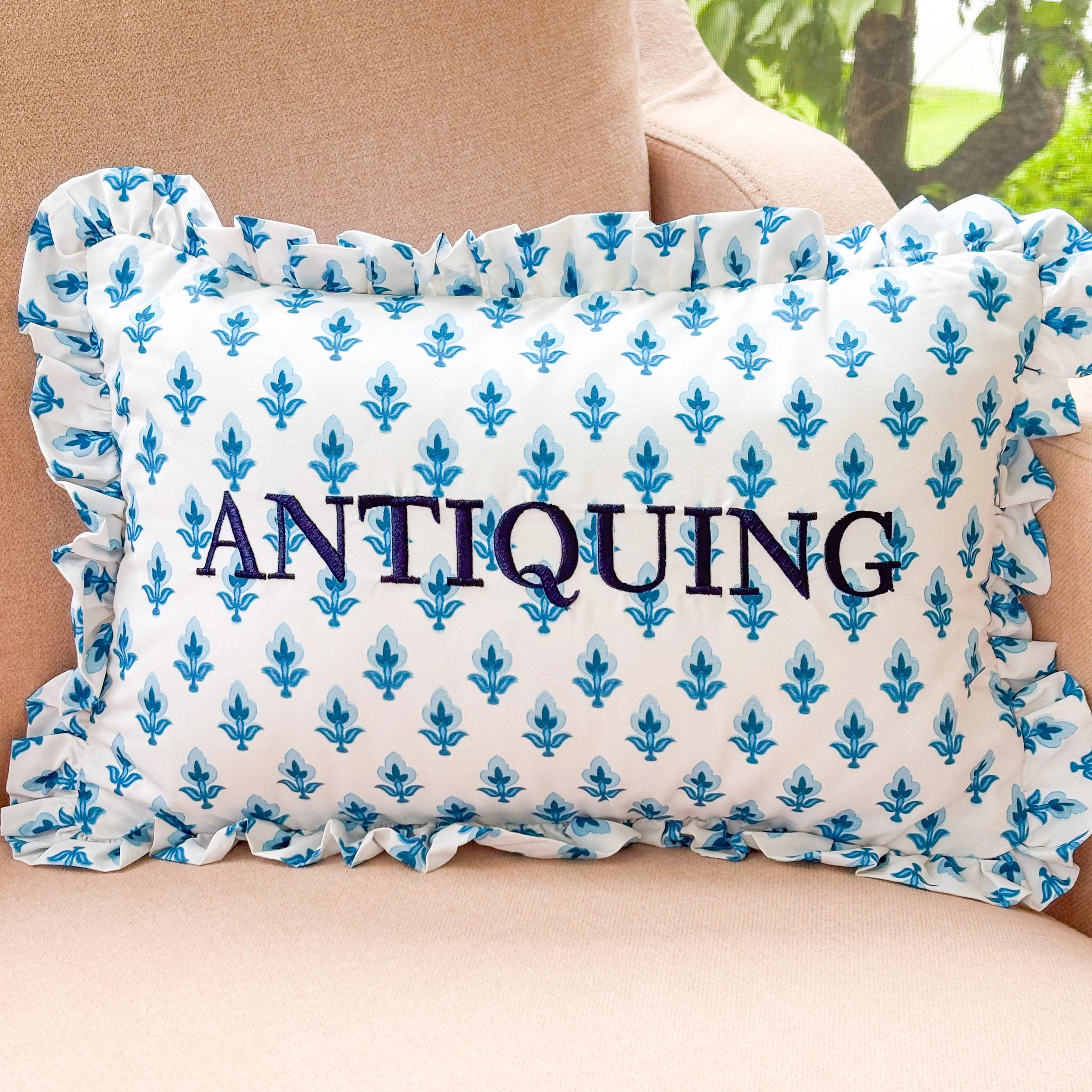 Decorative lumbar pillow featuring blue floral block-print style fabric.