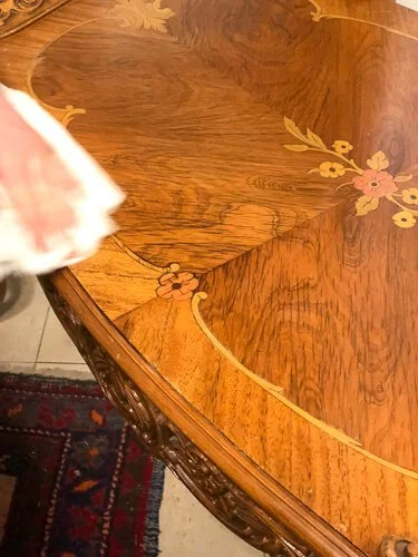 White rag wiping wood table