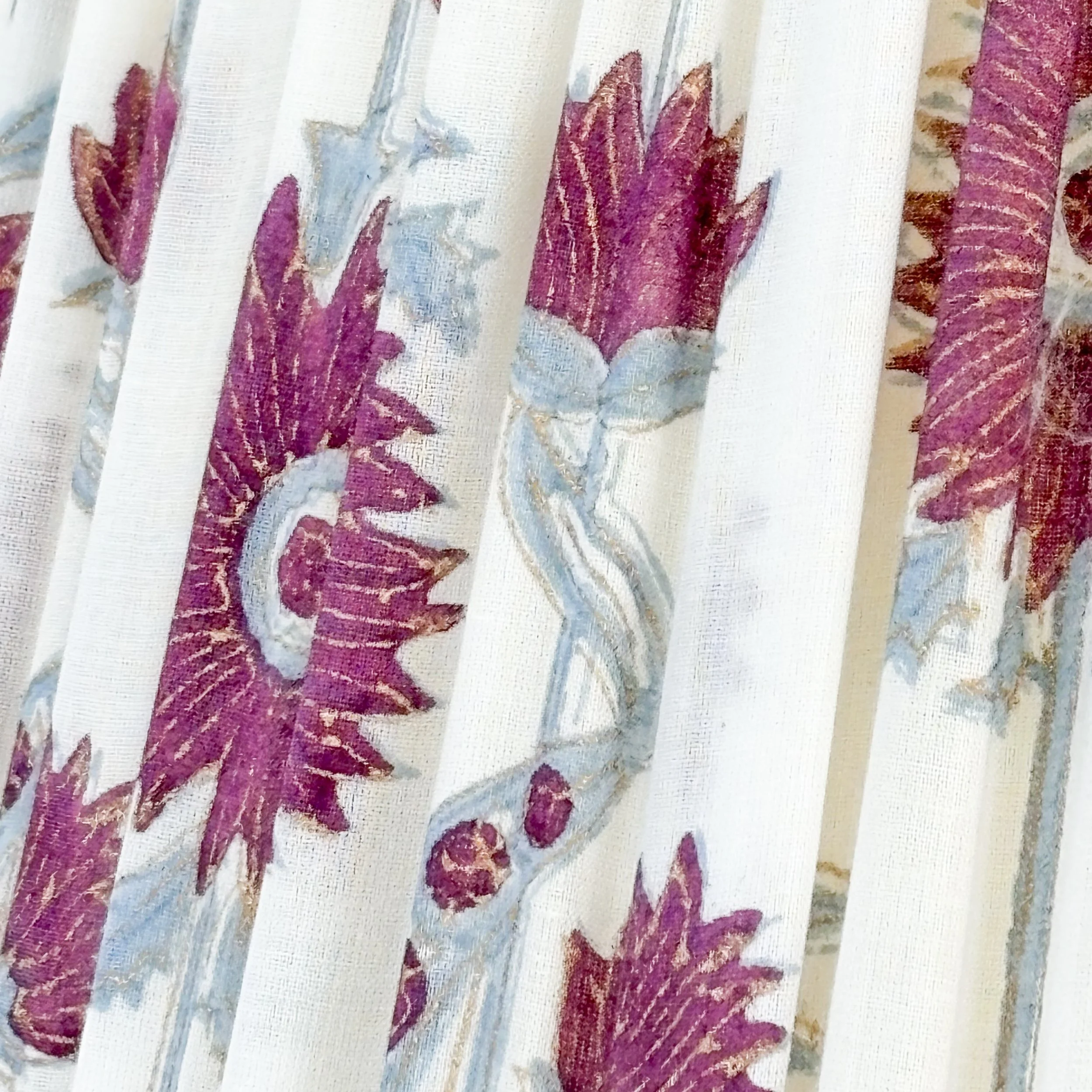 Decorative floral pleated lamp shade pair with vibrant purple trim detail.