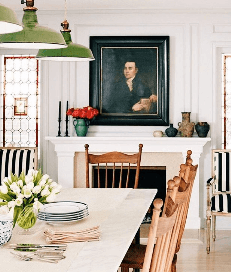 Antique portrait of a man in a dining room over a fireplace