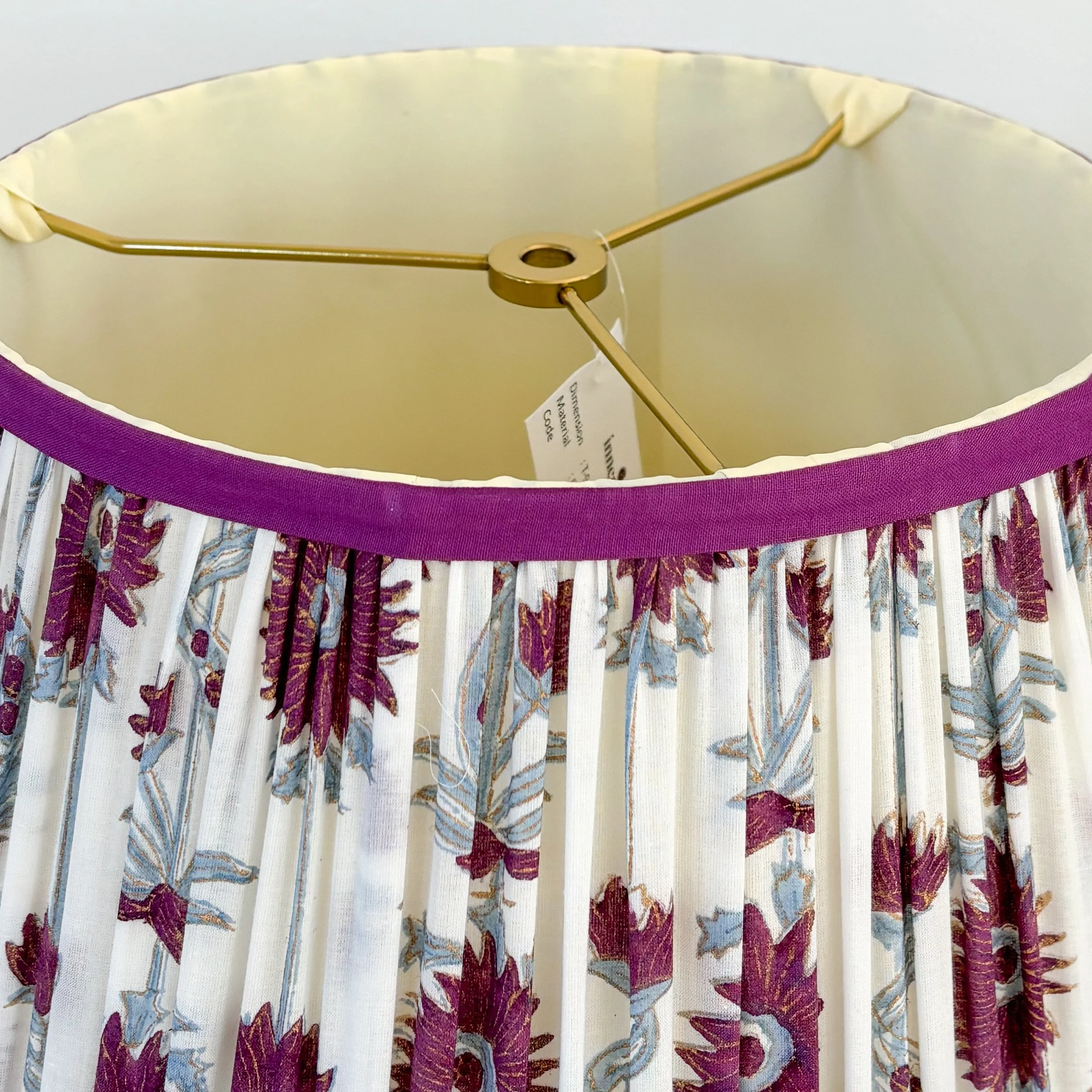 Pair of traditional fabric lampshades with purple and blue floral motif.