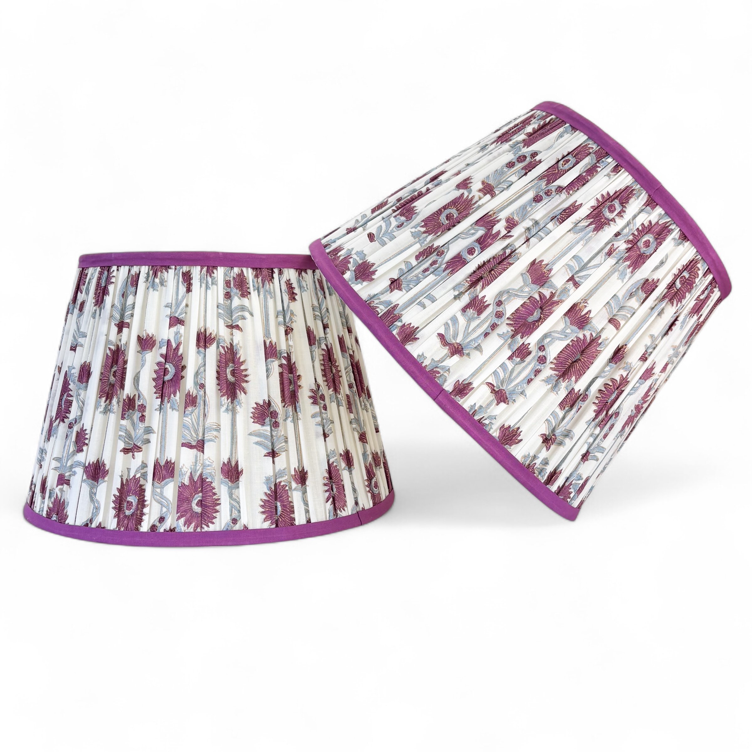 Pair of Purple Floral Pleated Lampshades with contrasting purple trim on a white background.