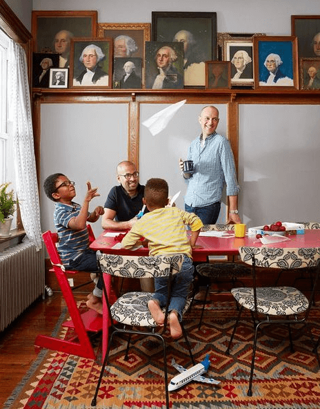Family at dining table surrounded by vintage George Washington portraits