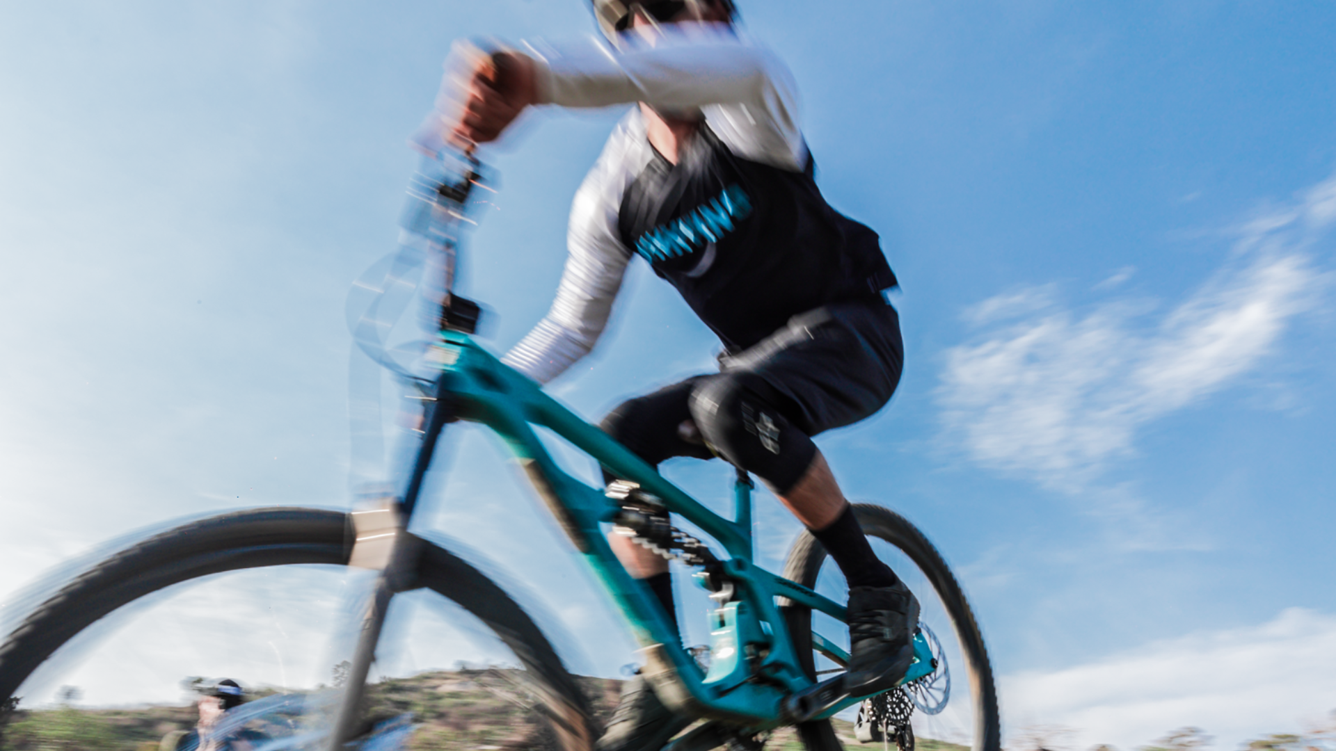 Motion blured capture of a mtb rider wearing the Monkeylion Bio Jersey