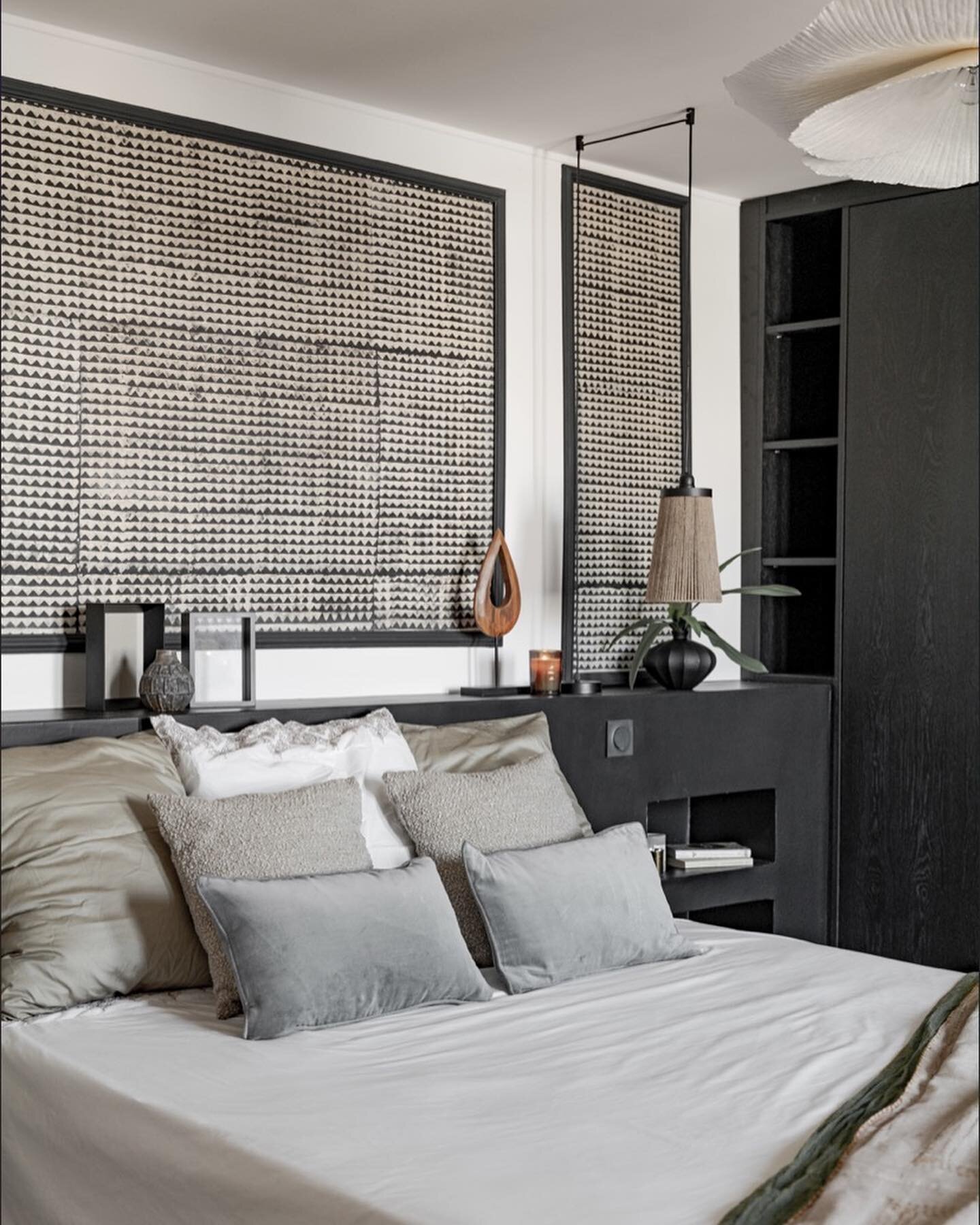 Project Bois - Voyage exotique 

Beautiful bedroom inspired by african textiles and design, this stunning bedroom features a bold black headwall, accentuated molding, and wardrobe, perfectly contrasted with crisp white. Infusing depth with rattan ele