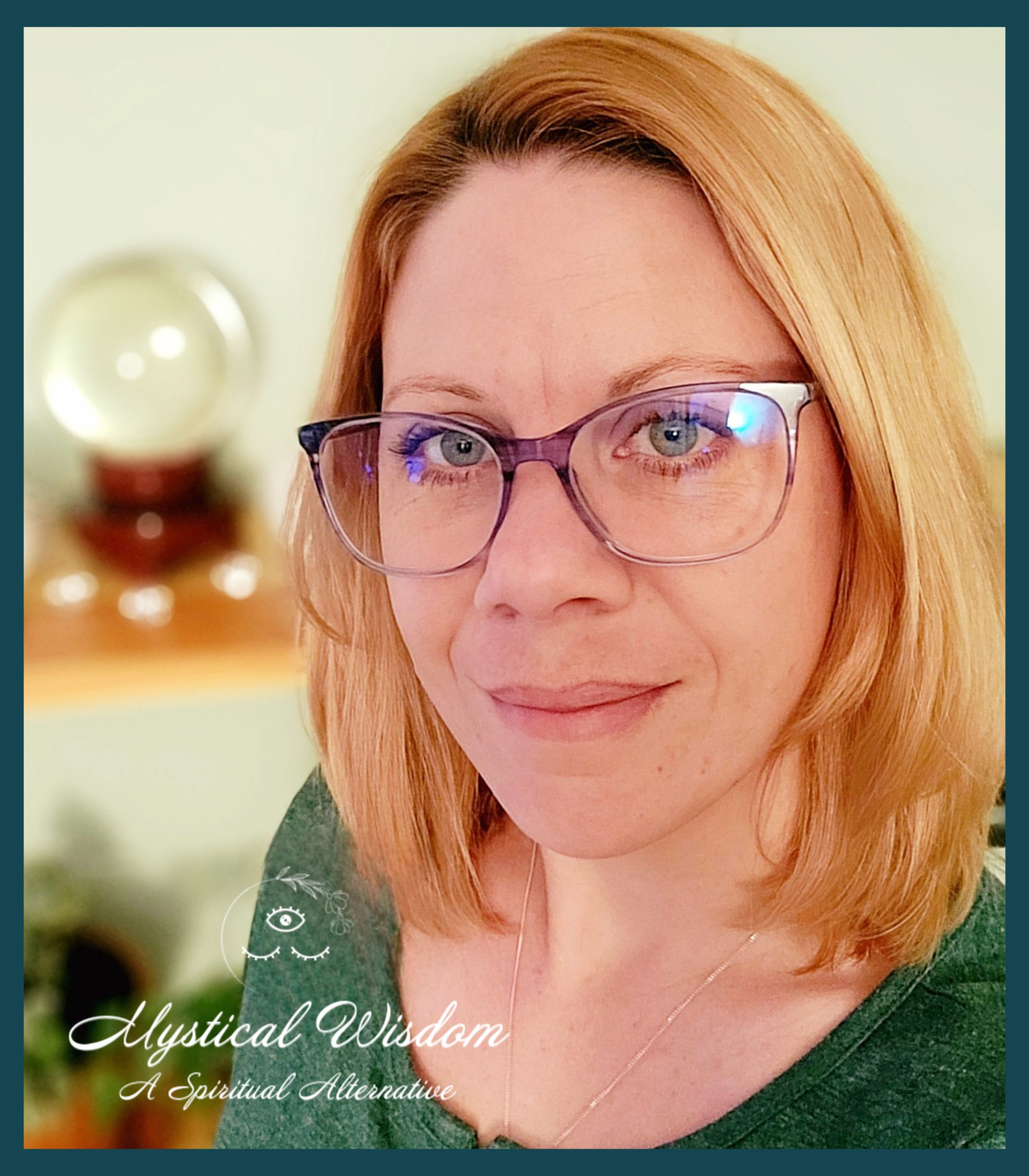 A woman with blond hair and glasses smiling indoors with a blurred background that includes a globe on a table.