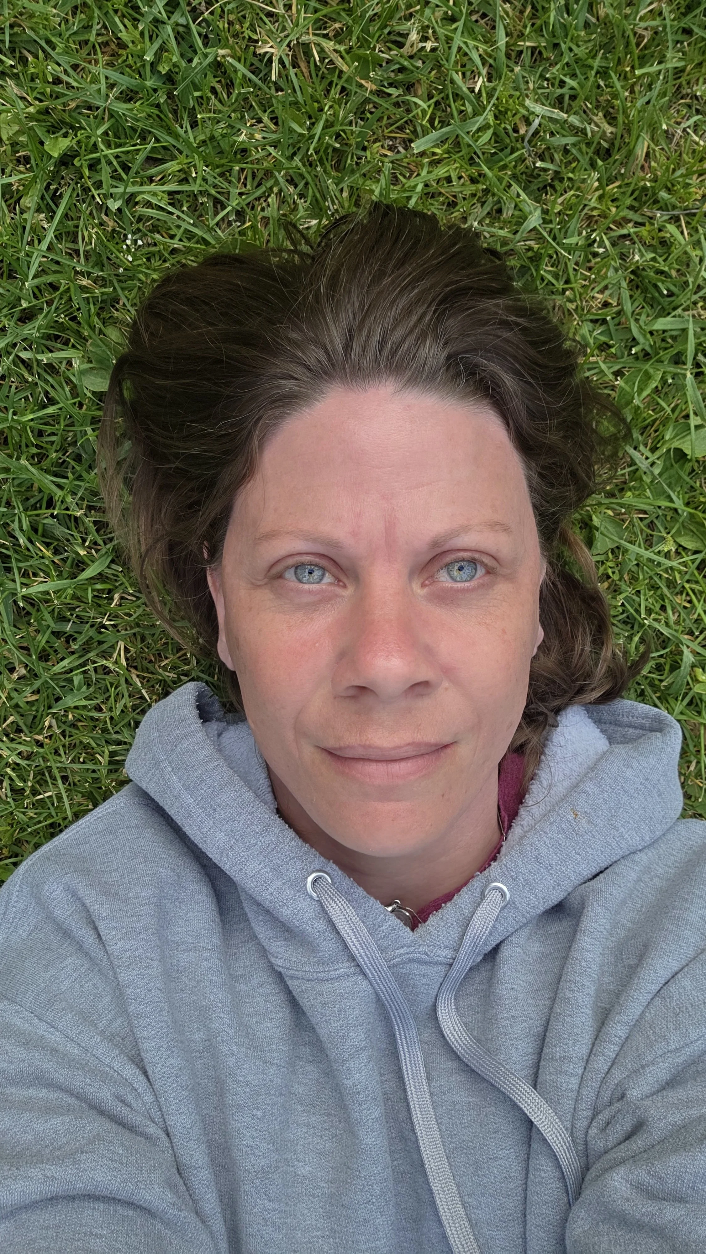 Sharla Davenport laying on the grass looking up at the sky