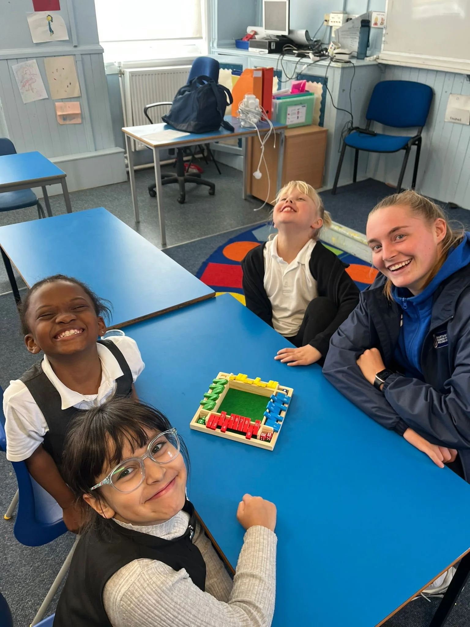 Group of children in school with a youth worker