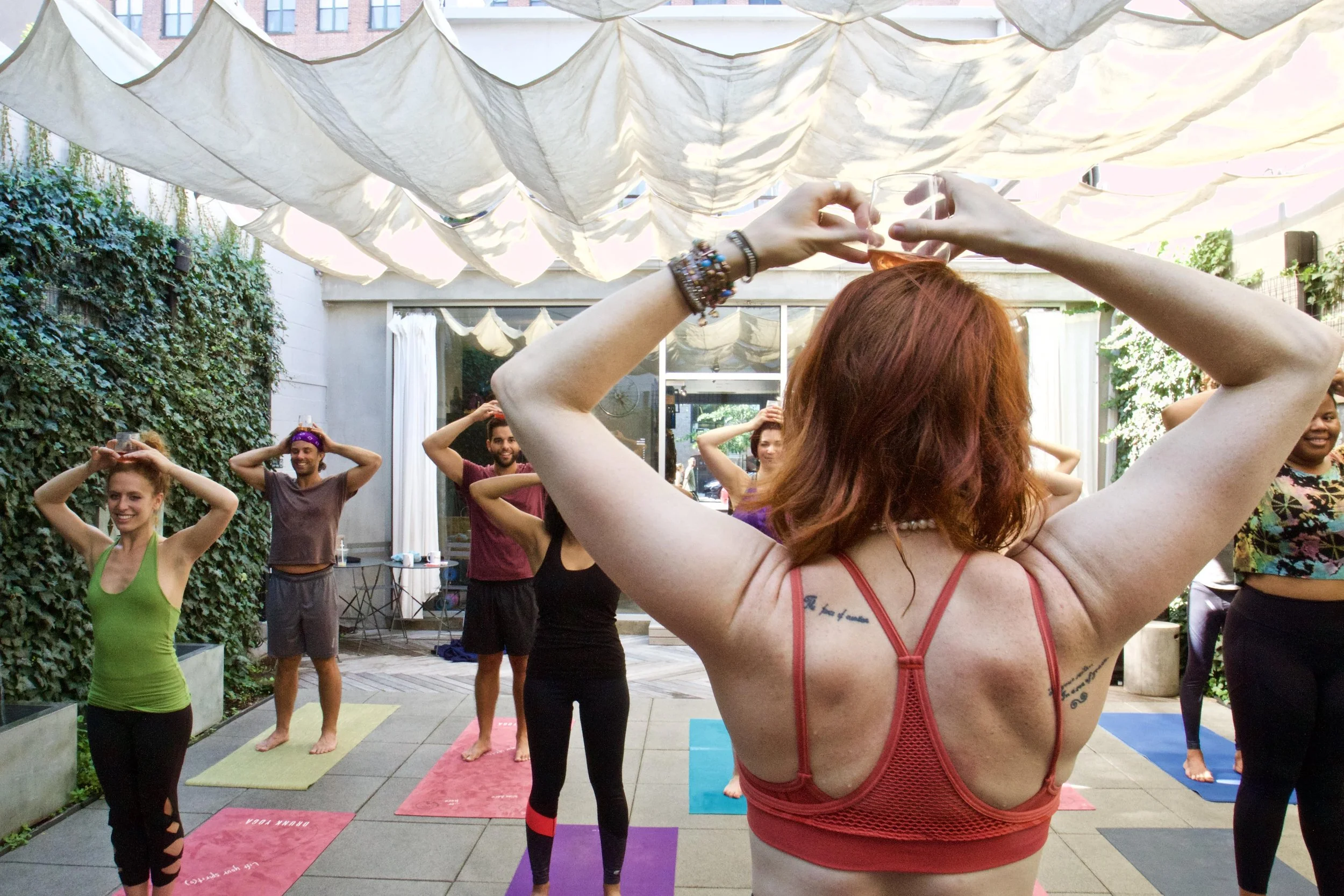 wine and yoga, drunk yoga, corporate wellness, fun yoga, uplift, belong