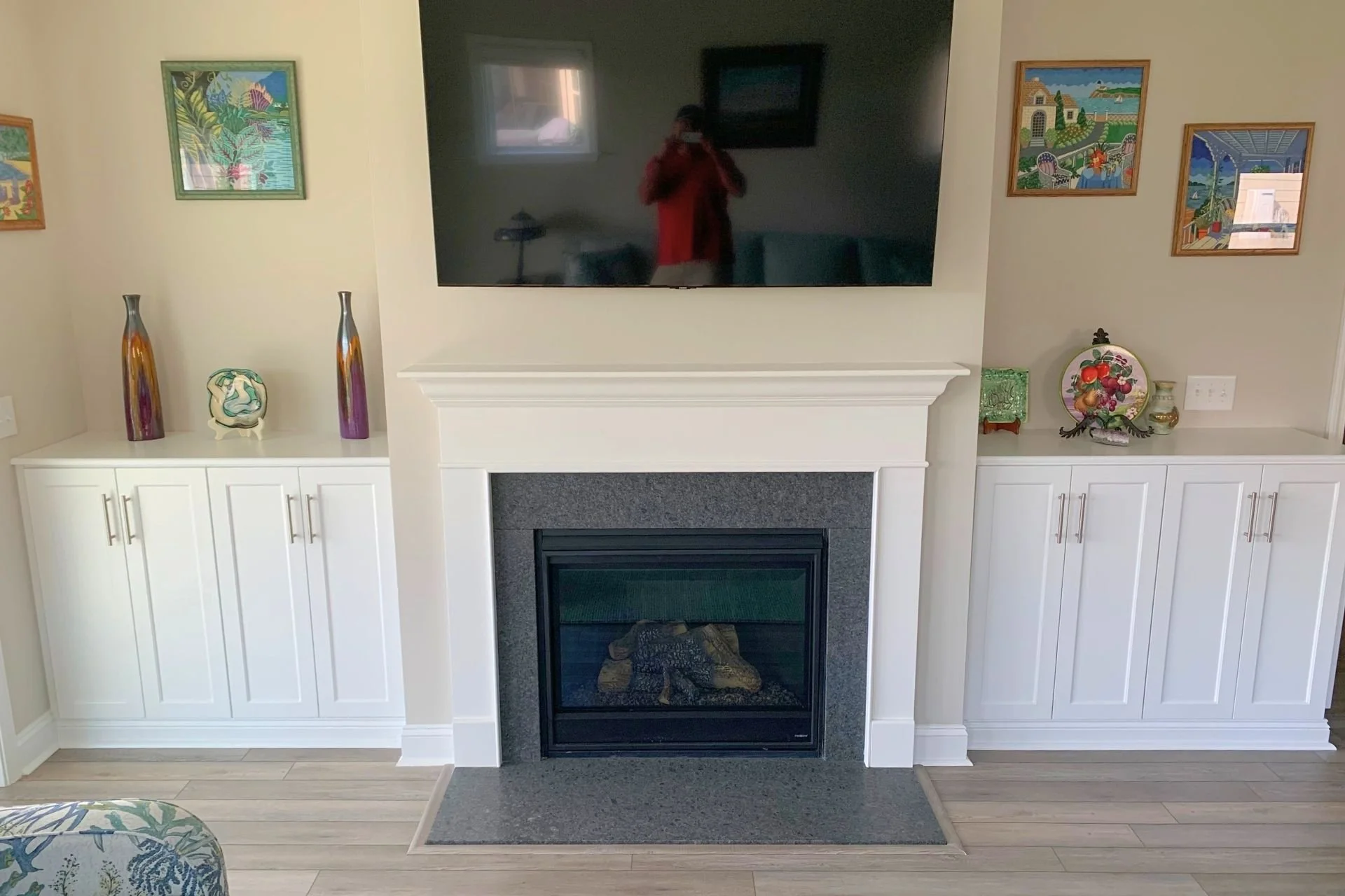 Livingroom built-in with TV above it and painting on the wall