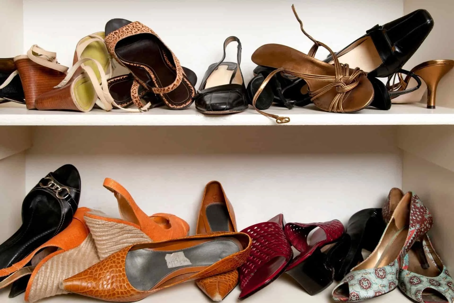 disorganized shoes on three shelves