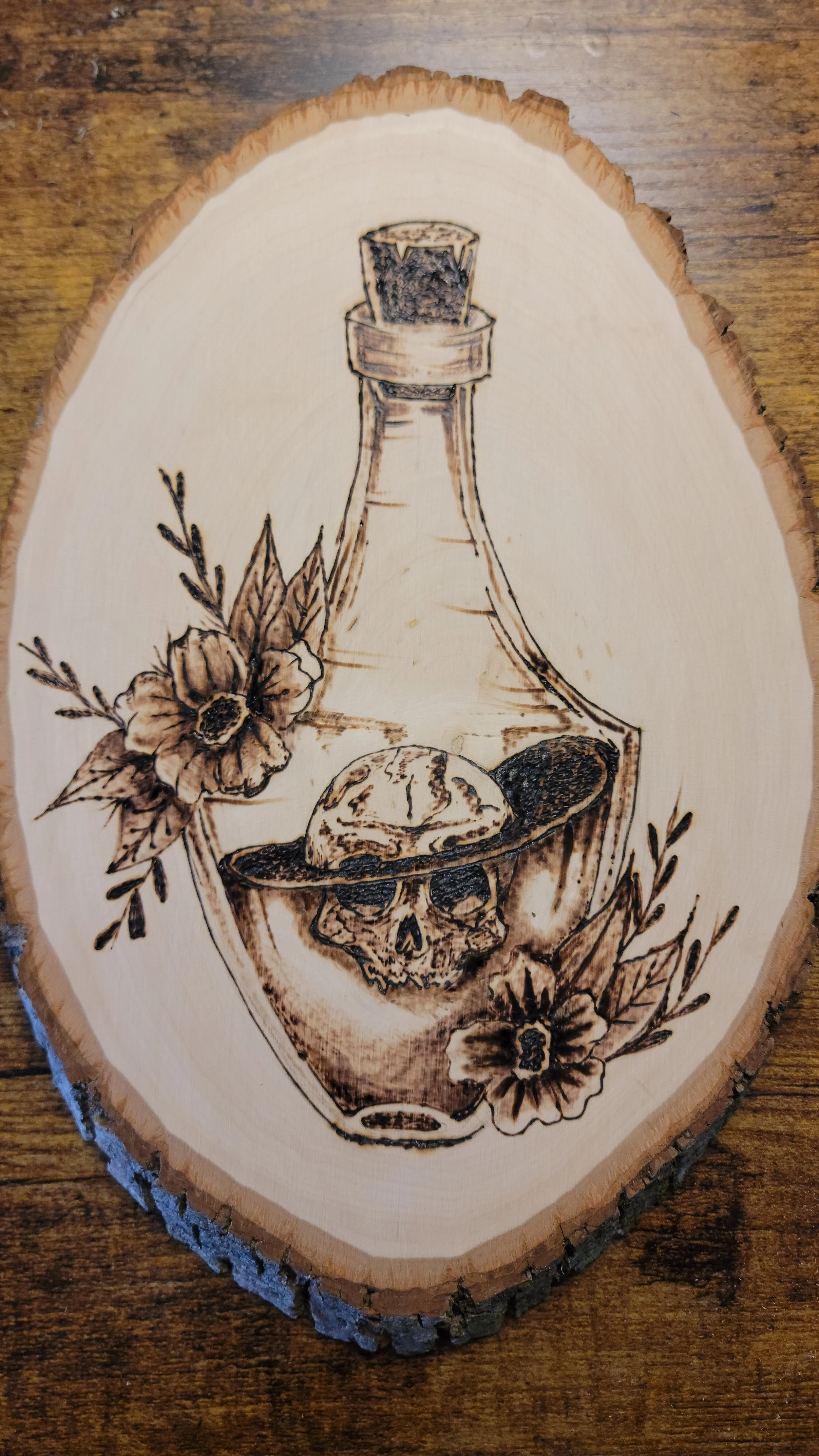 Skull In a Bottle – Original Woodburned Art on Live Edge Basswood