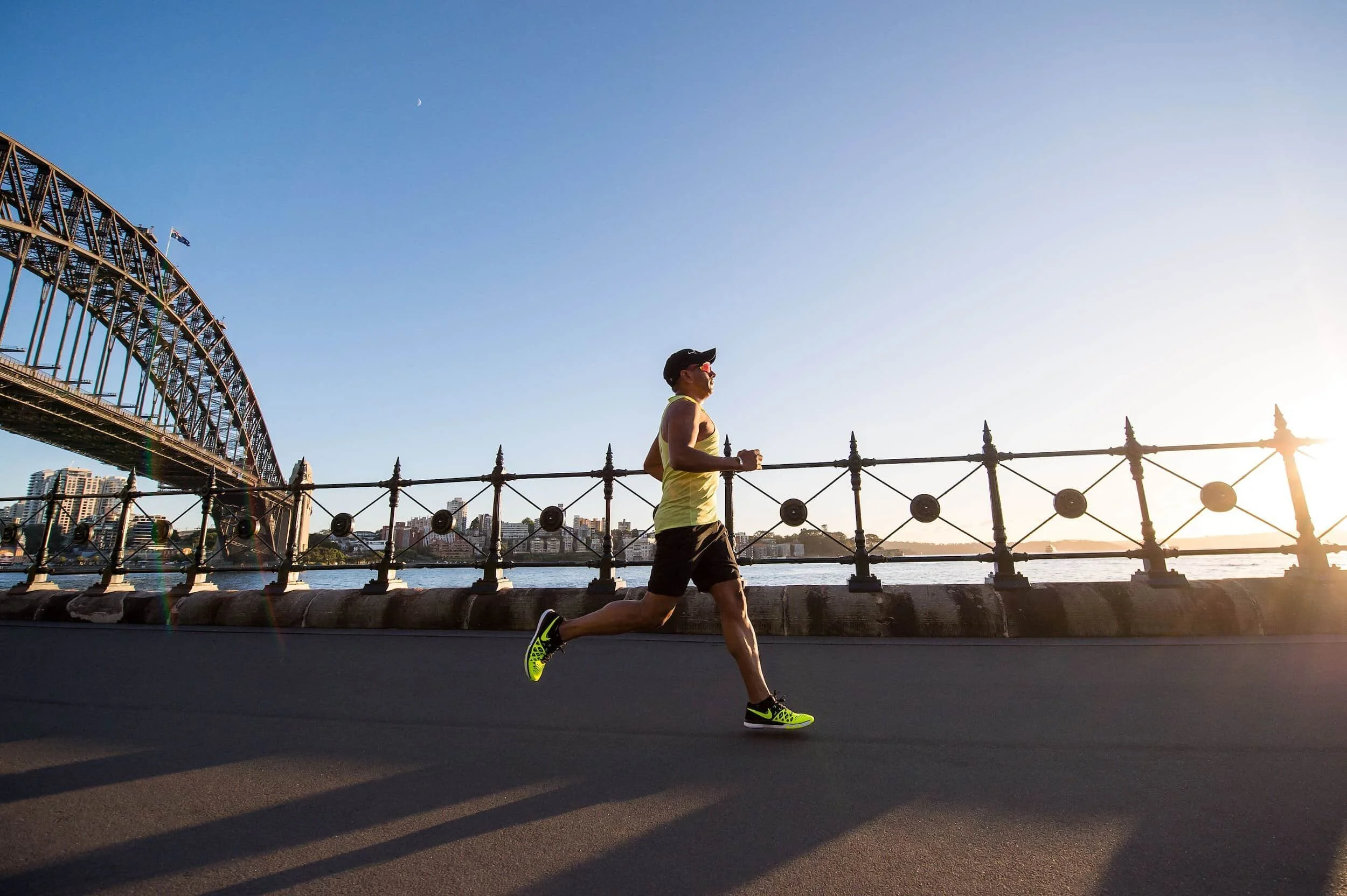 Man in athletic gear running alongside river