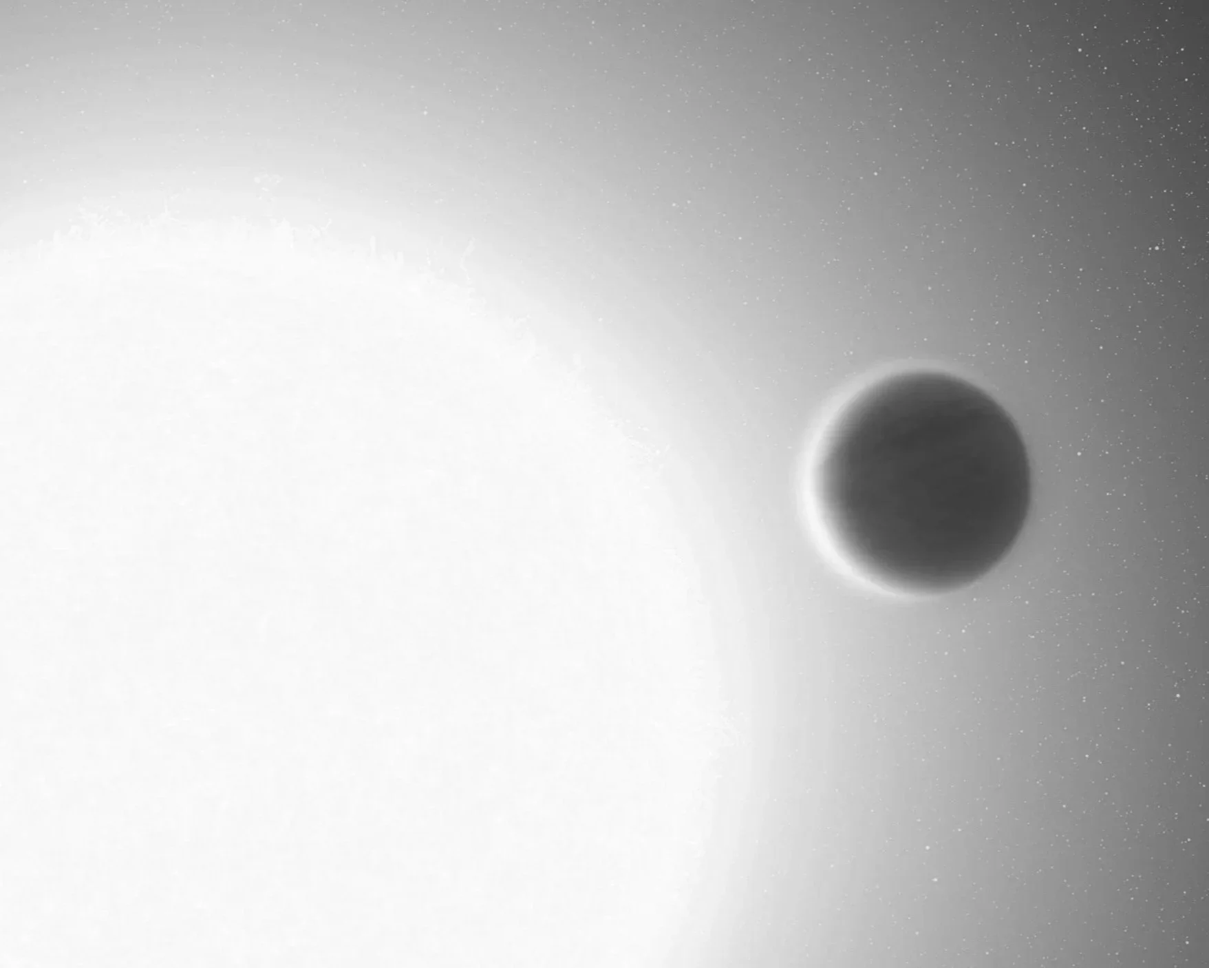 A black circle resembling a celestial body, such as a moon or planet, against a background filled with stars.