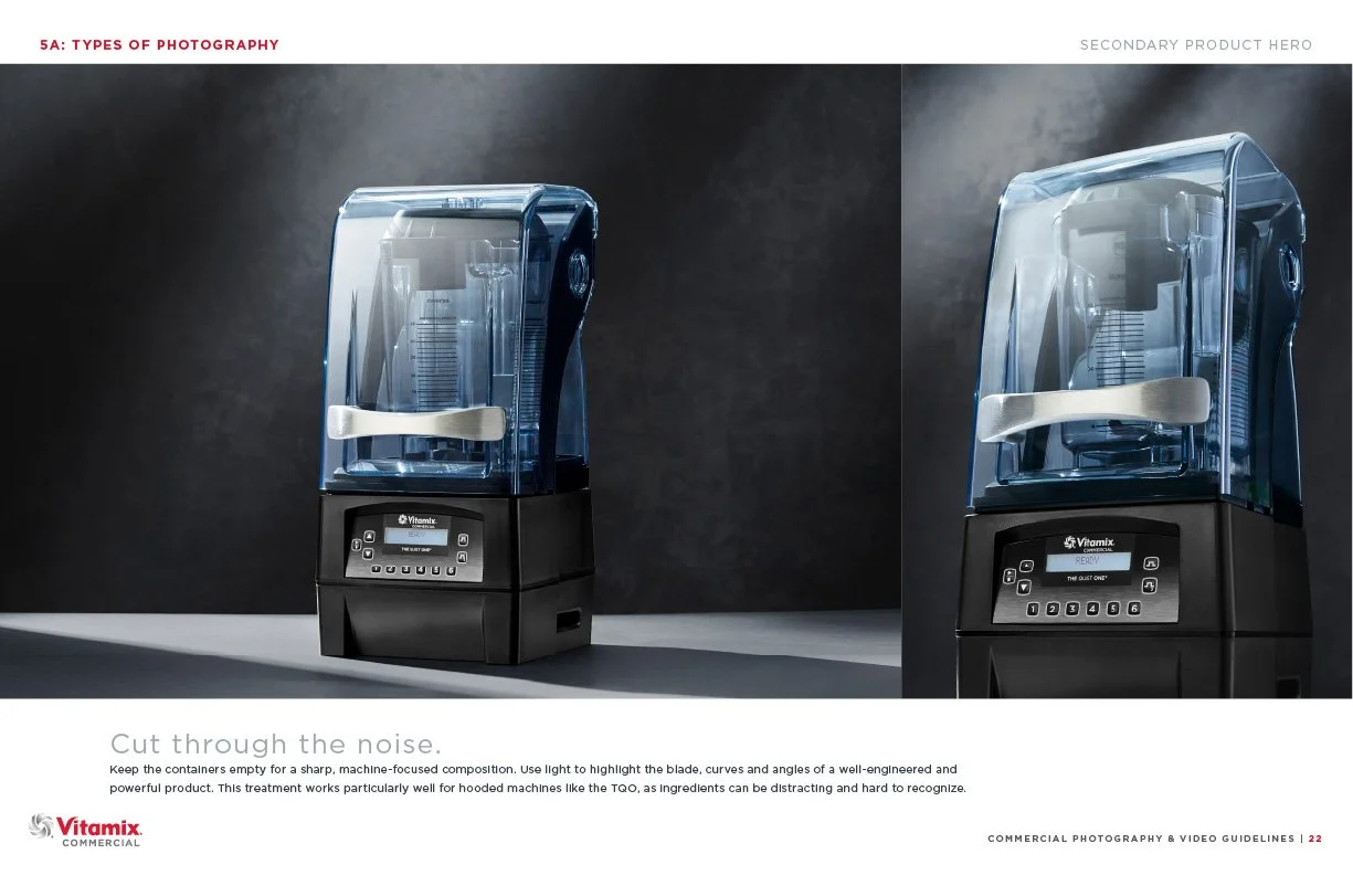 Two Vitamix commercial blenders with clear containers and digital touch screens on a dark background.