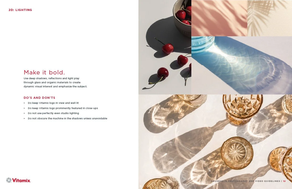 Photograph of cherries on a white surface, casting dark shadows, and glassware creating patterns with reflections and light, set against a light-colored background.