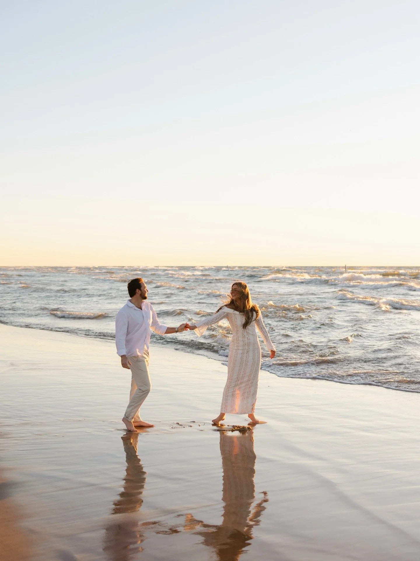 Lydia &amp; Sandro💍🤍

There&rsquo;s something about Lake MI in the warmer months that just softens everything&mdash;even when the wind has other plans. During L+S&rsquo;s engagement session, the breeze was wild, whipping off the lake and sending ha