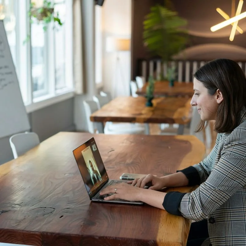 Woman_sat_at_table_on_Video_Call.jpg