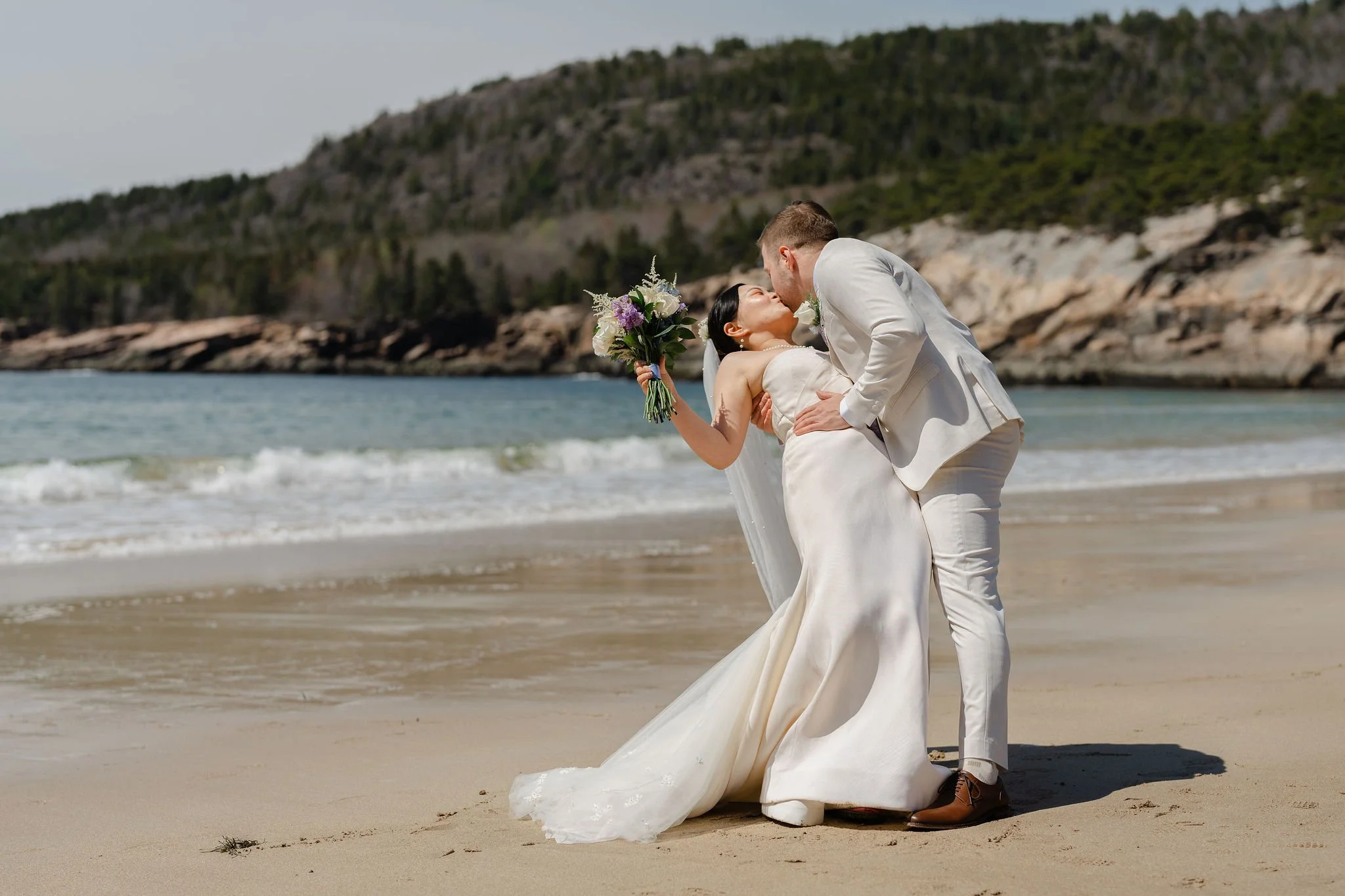 Bride and Groom kissing on Sand Beach in Acadia National Park during Acadia elopement