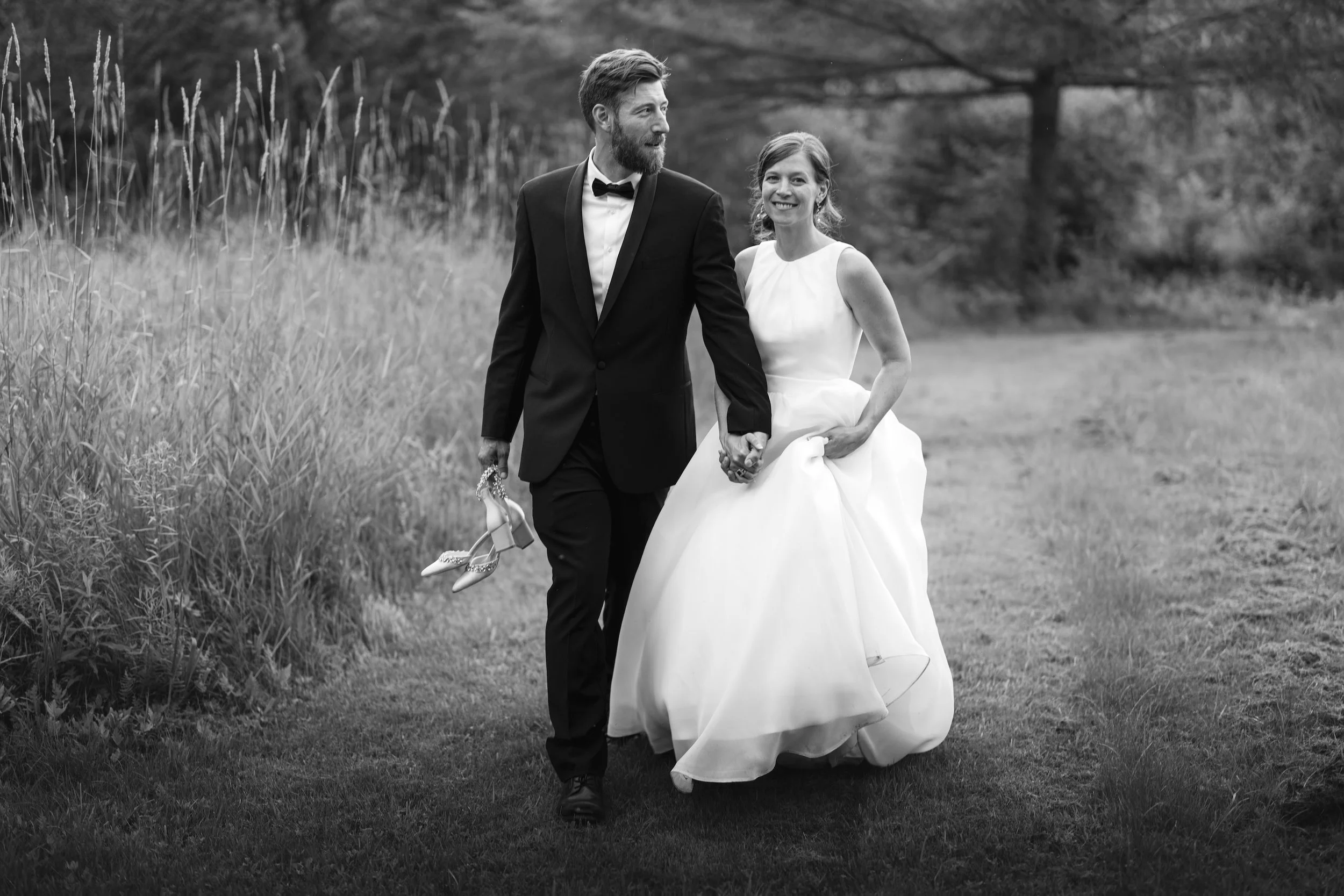 A black and white portrait of a bride and groom in rural Maine wedding setting