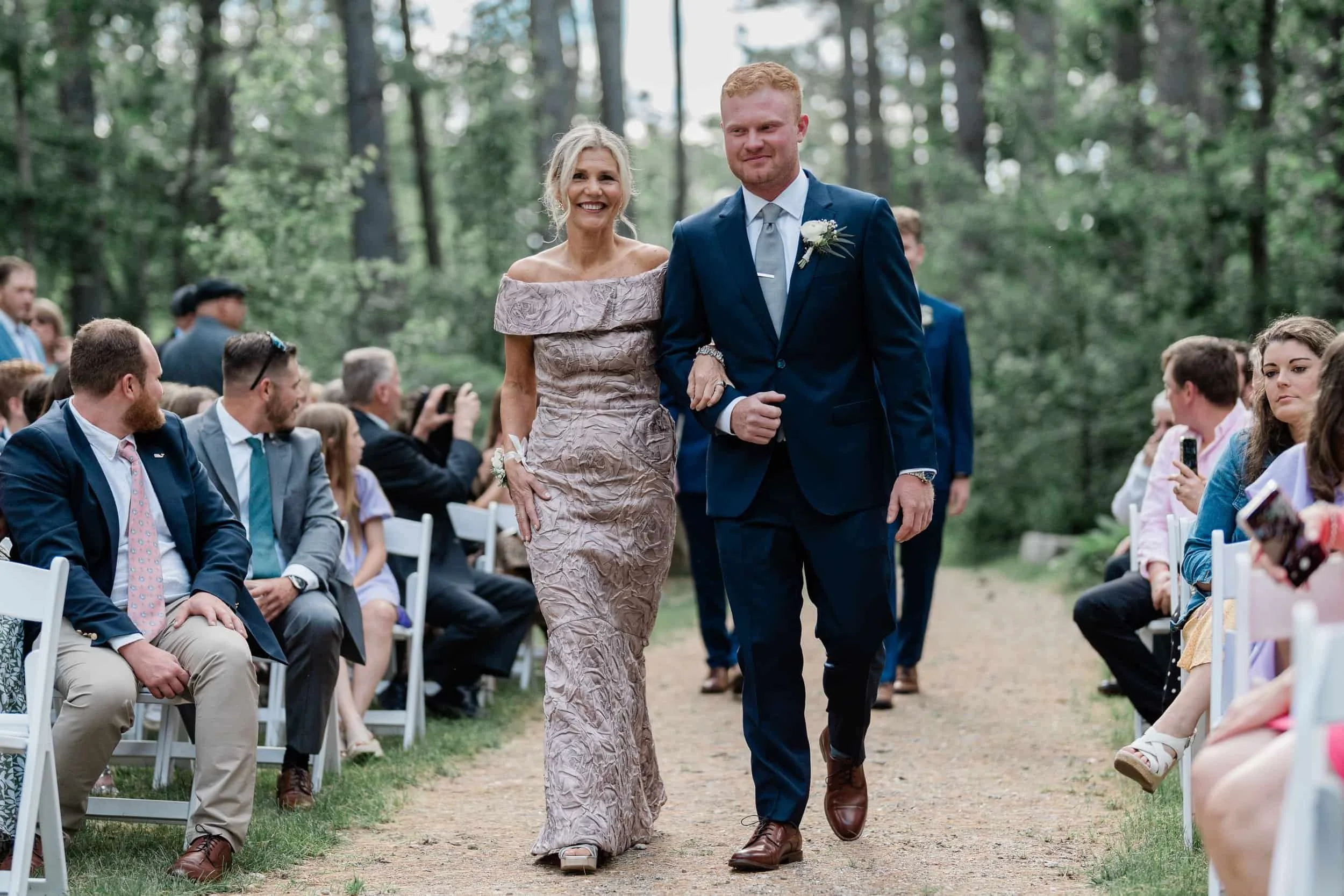 Groom and mother smiling during the wedding ceremony in Fryeburg, Maine.