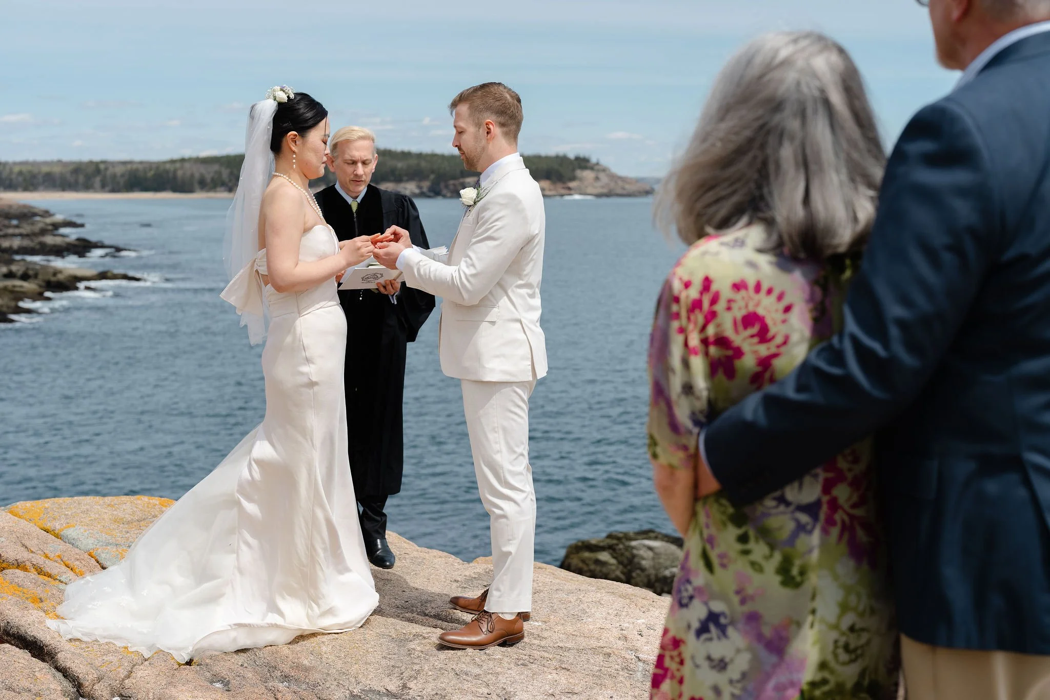Bride and groom exchanging rings during Acadia Elopement by Warner Photography