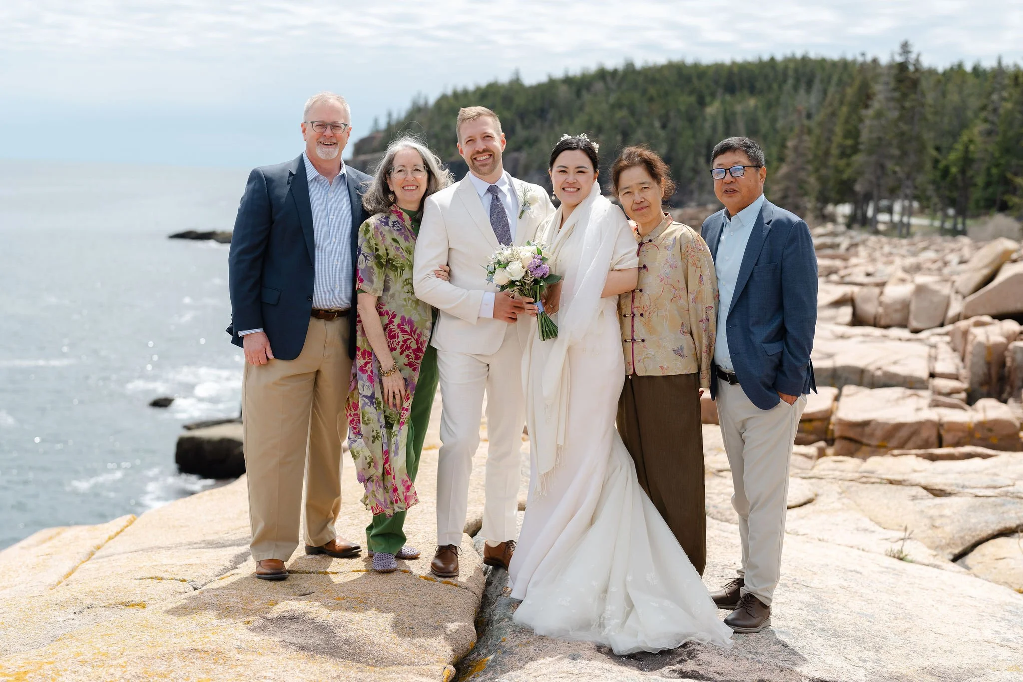 Bride and groom in family photo in Acadia National Park by Warner Photography