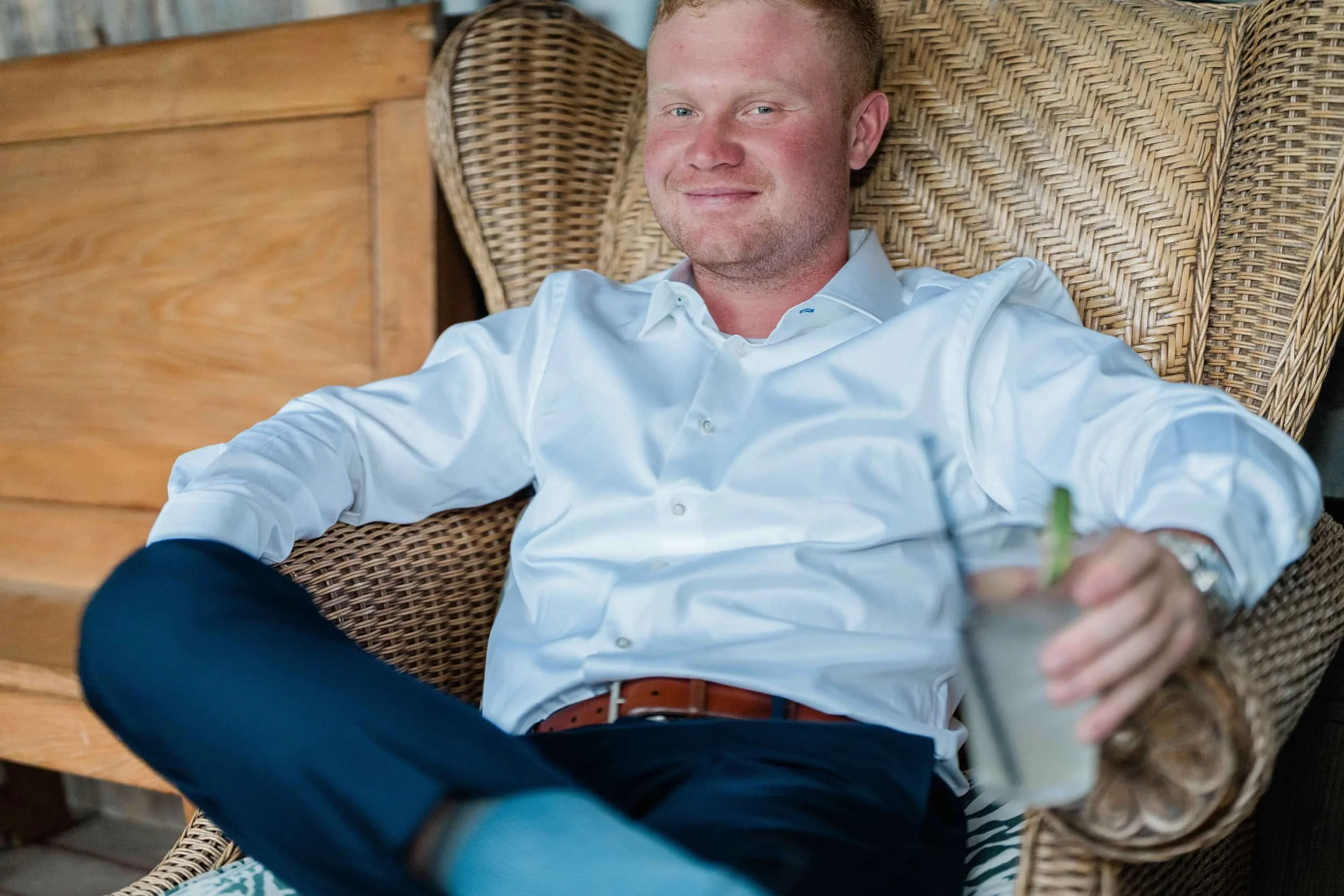 Groom relaxing before the ceremony at Old Saco Inn wedding in Fryeburg, Maine.