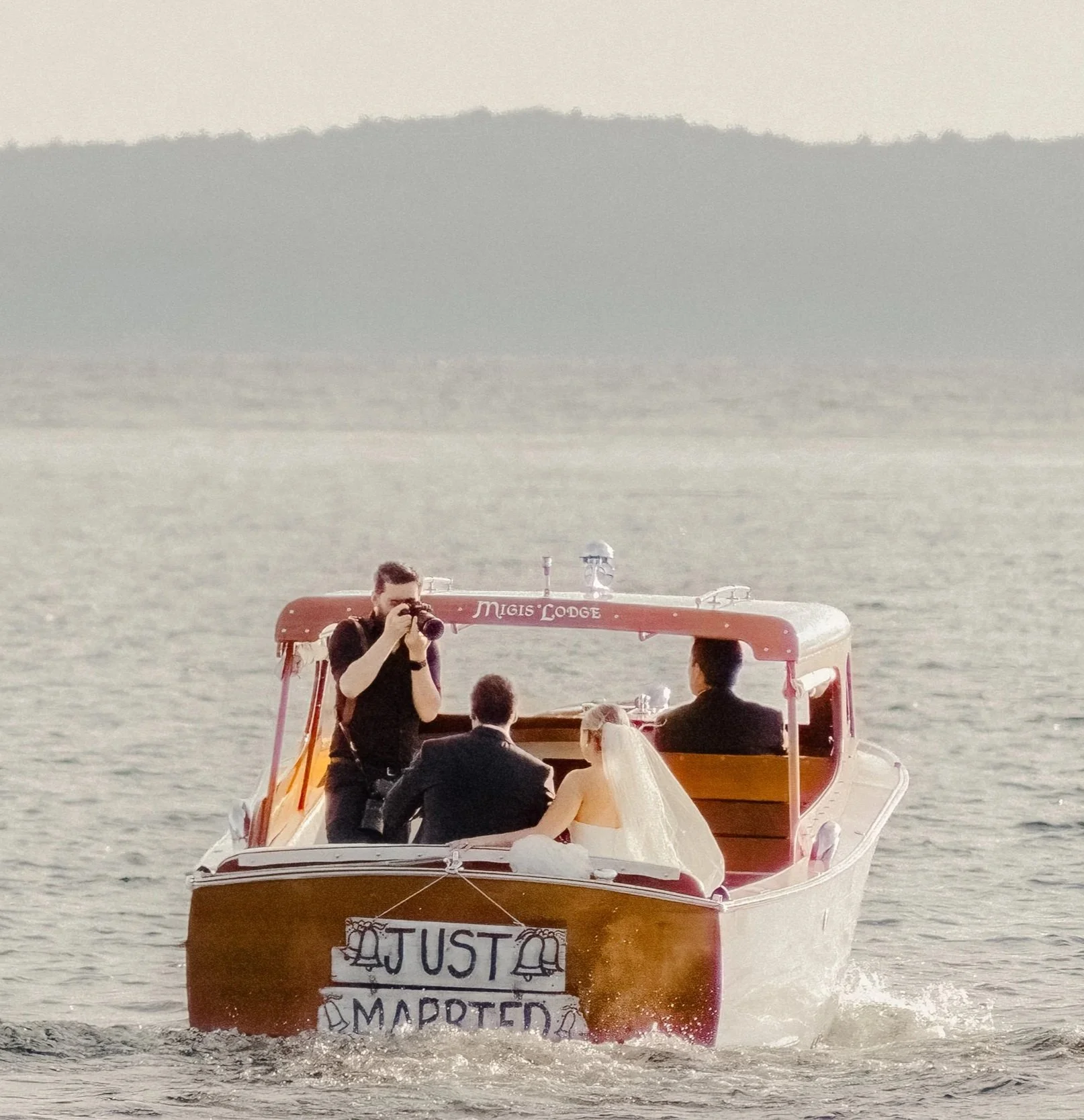 Ned Warner photograhing newlyweds  bride and groom at Migis Lodge wedding in Maine