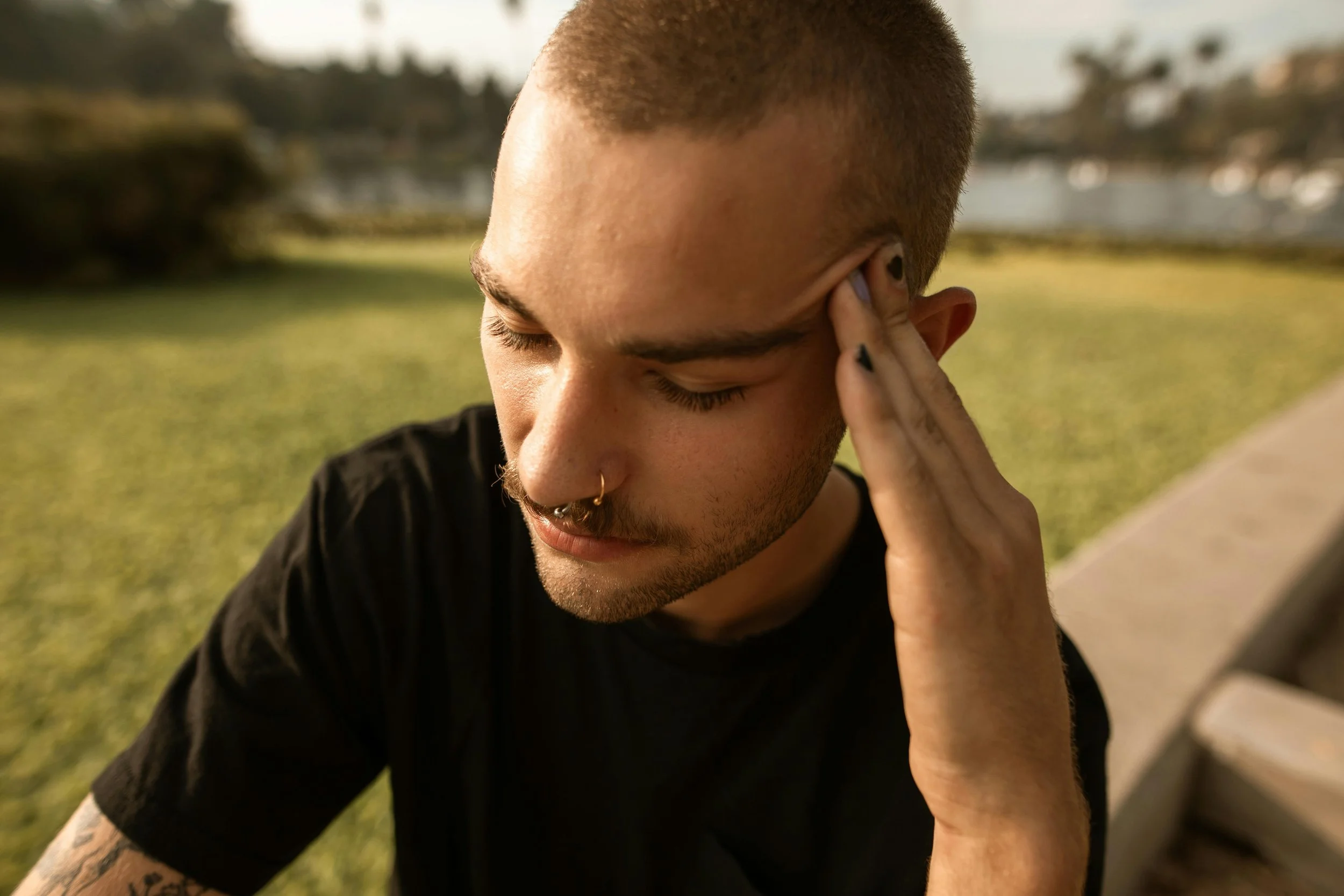 Man holding his head while experiencing intrusive thoughts and mental overwhelm