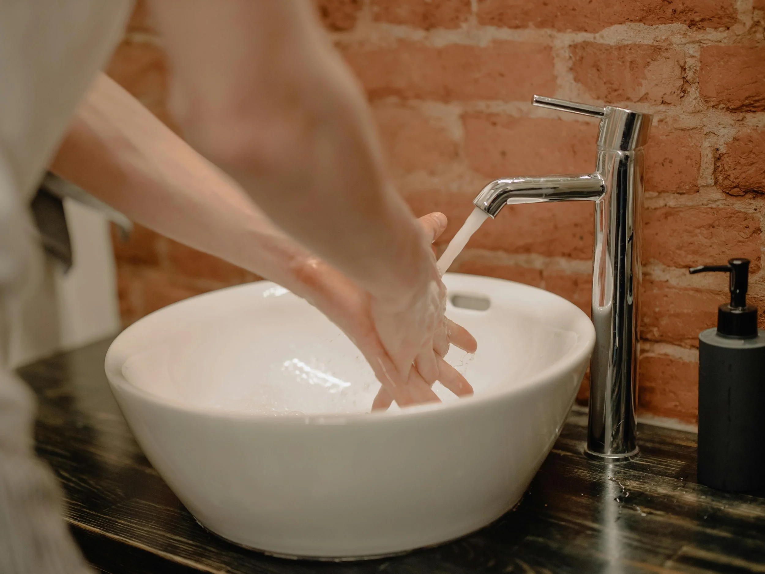 Person washing hands to illustrate compulsive behaviors addressed in OCD therapy and counseling in Arizona.