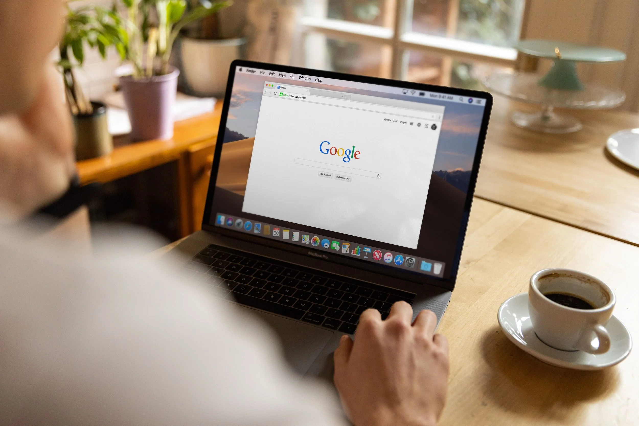 Person using Google on a laptop while searching for OCD symptoms and mental health wellness resources.