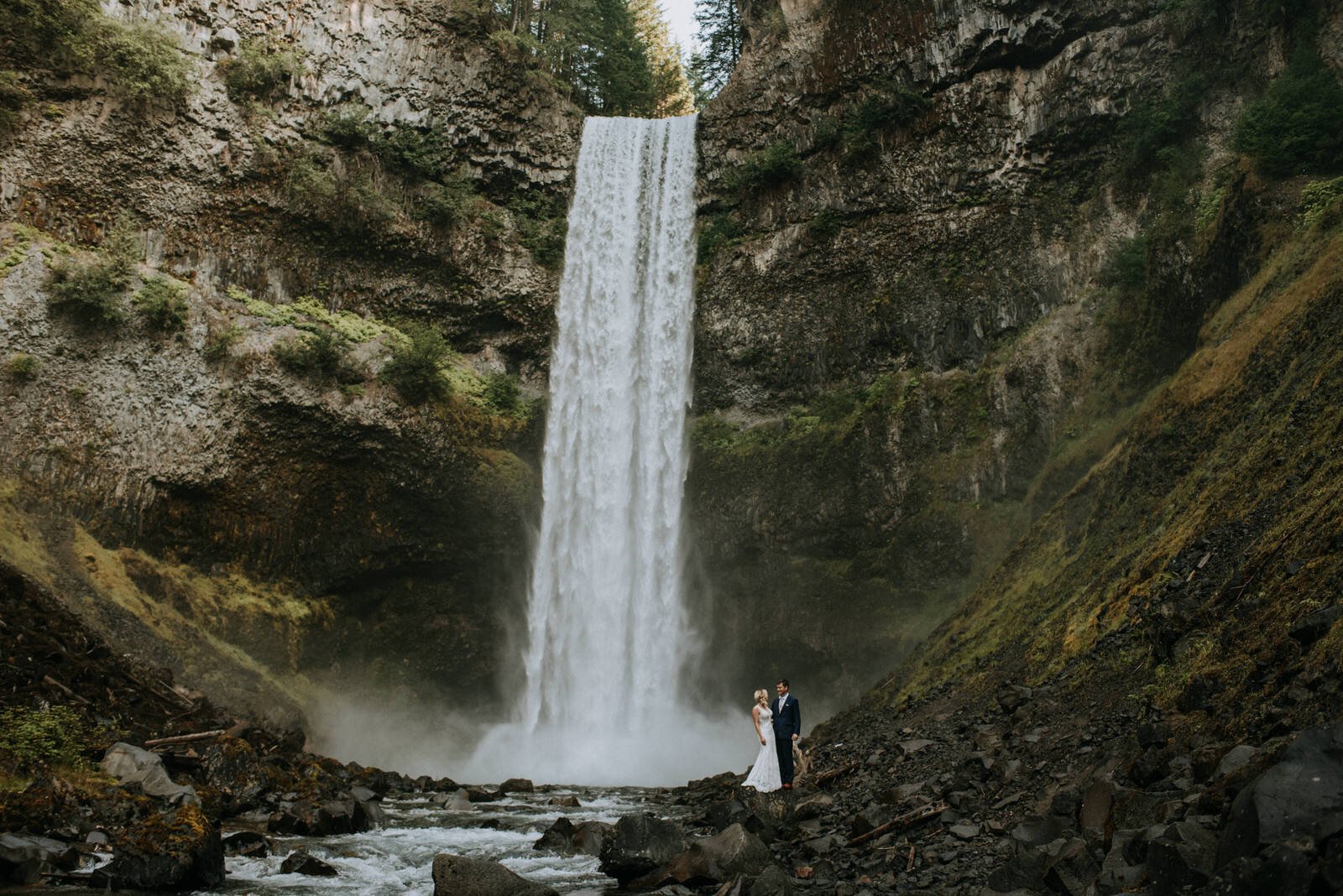 Bride and Groom standing in front of Brandywine waterfall 