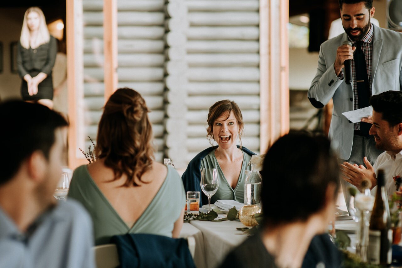 bridesmaid laughing during speeches wedding reception