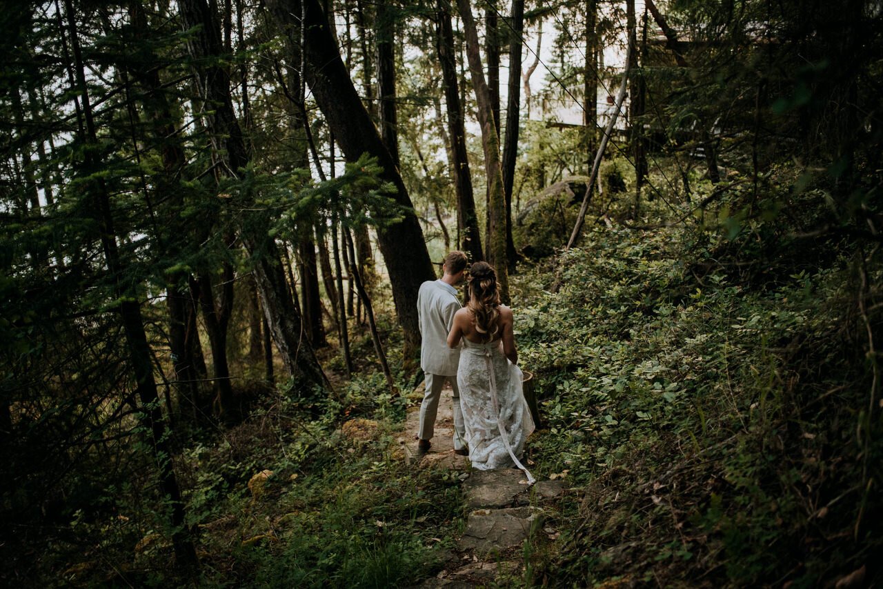 bride and groom walking down stairs in forest galiano island