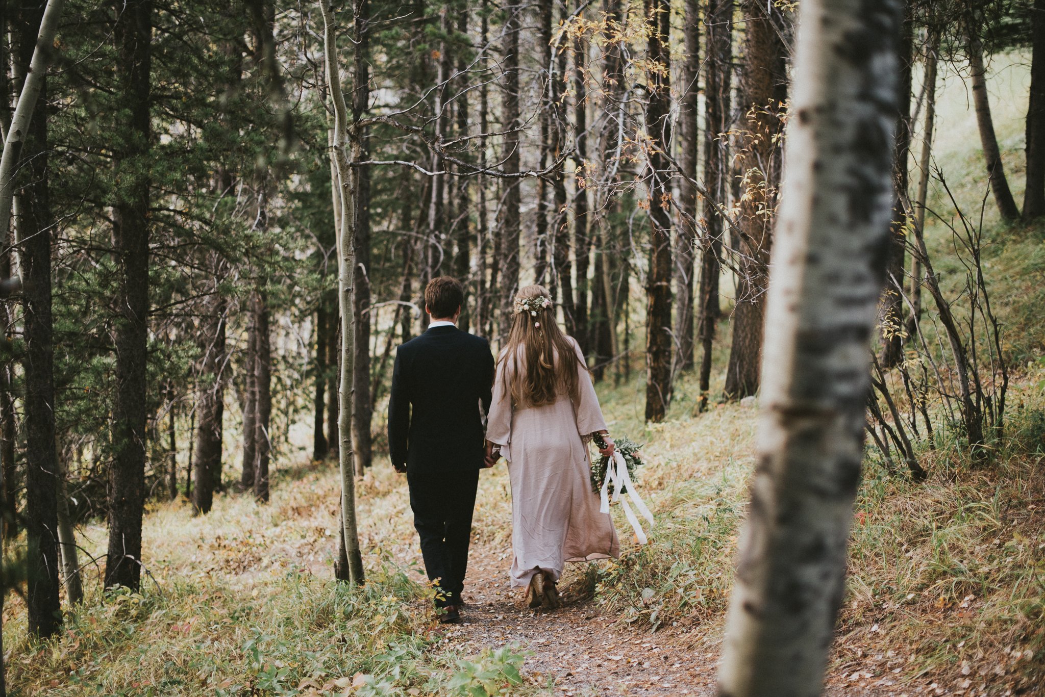 bride groom walking forest elopement kananaskis