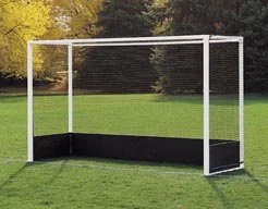 Soccer goal with white frame and black net on grassy field