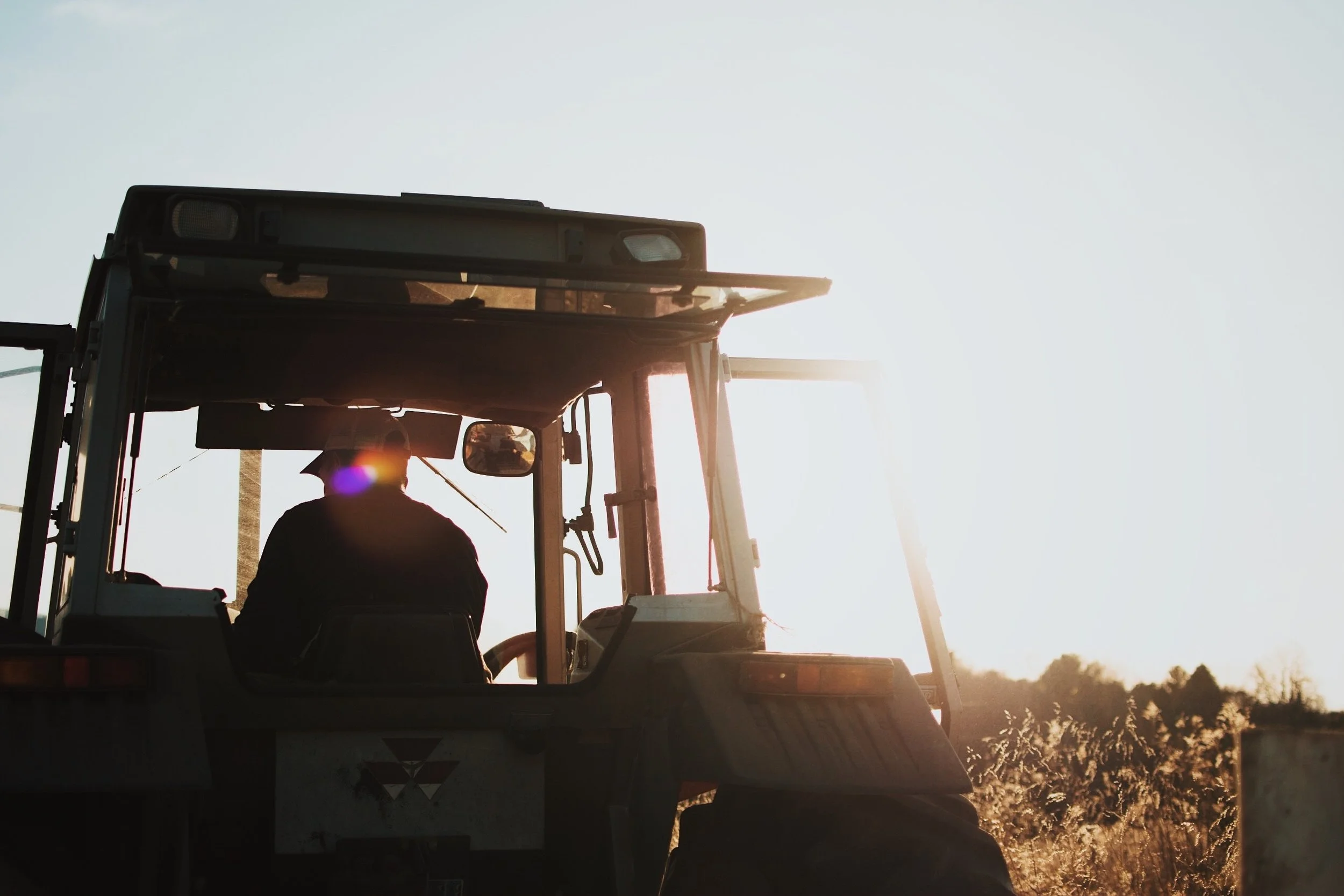 Tractor driver on a driving a tractor.