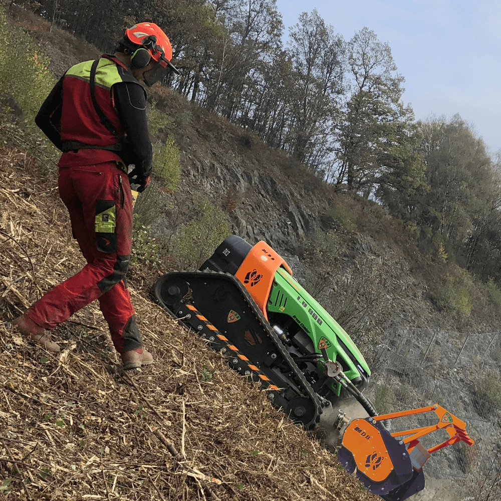Green Climber operating on a roadside slope