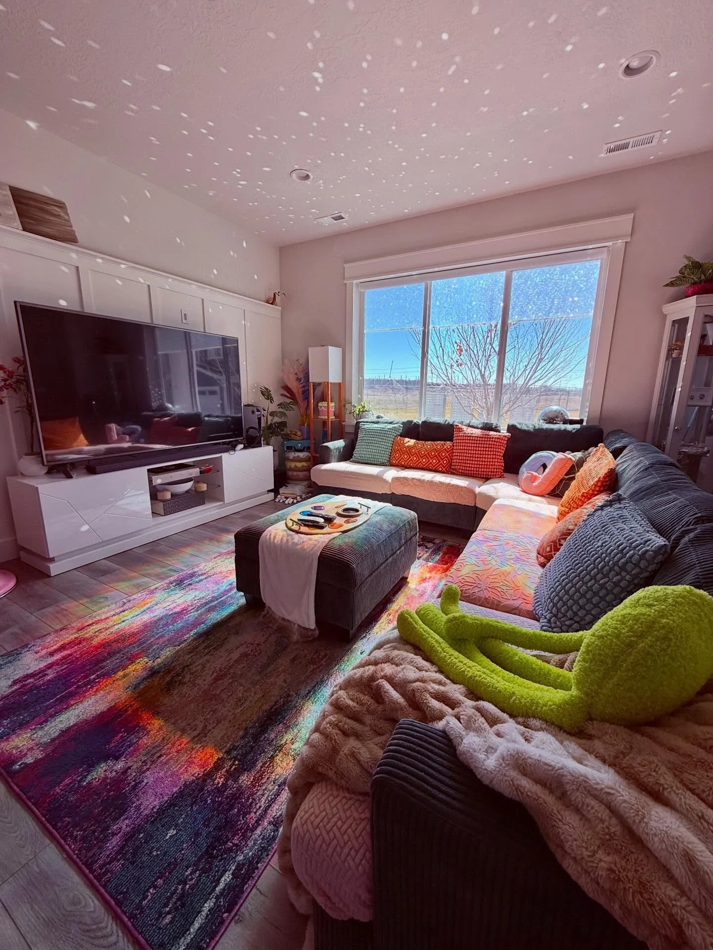 Disco balls and rainbow film are the greatest inventions of all time. Even without my stuff hung up on all the walls it looks so happy and interesting in here with the lighting effects🥰🥰🌈 #homedecor #pasteldecor #maximalist #rainbow #home