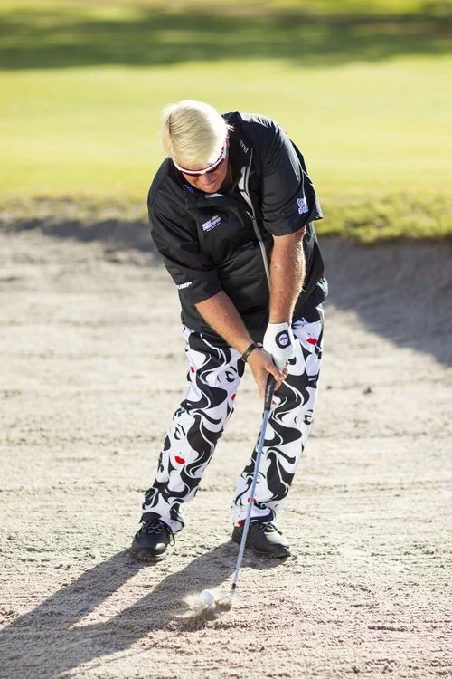 John Daly golfing in a sand trap by Cameron Melcher for Rhone Creative and rock bottom golf