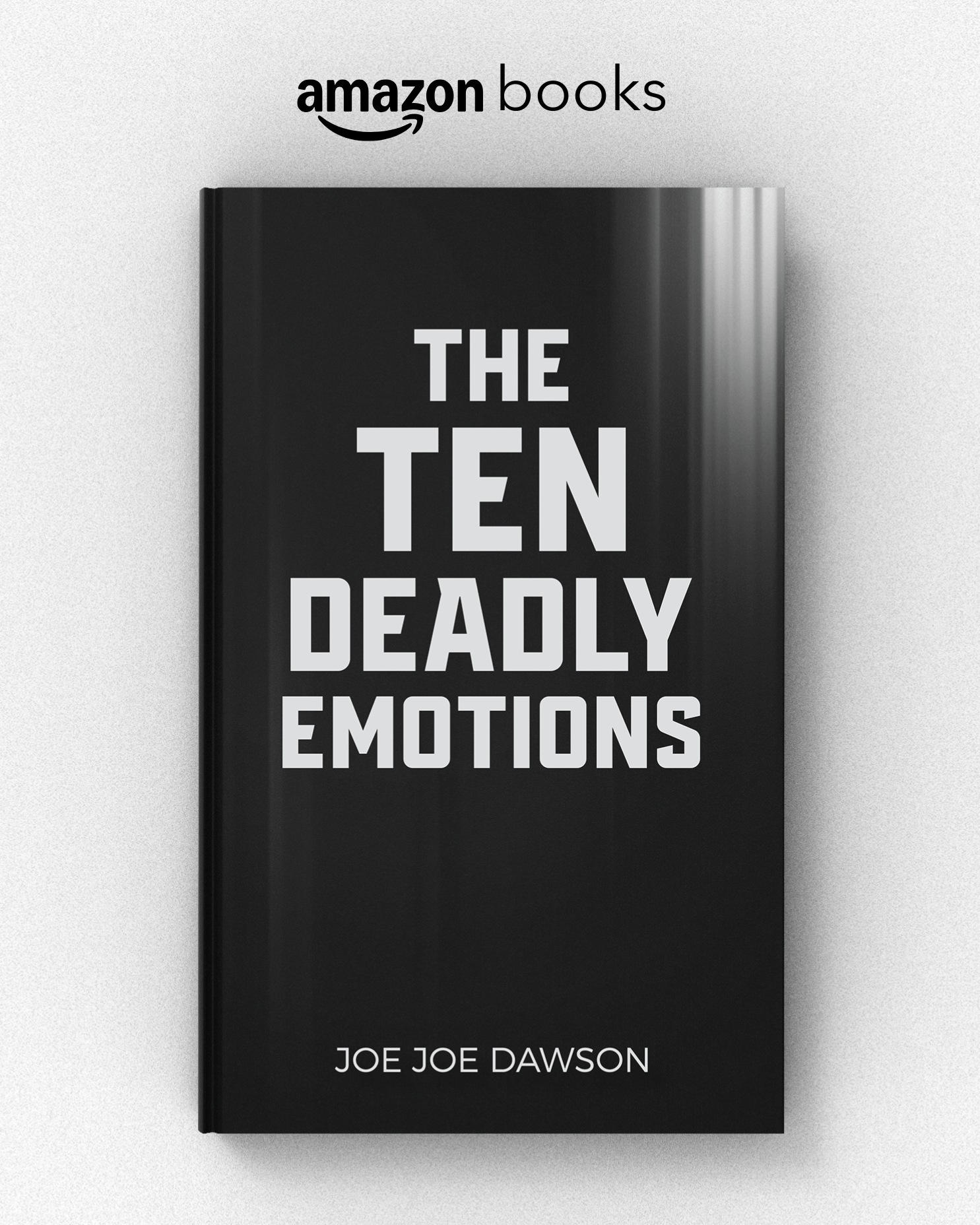 A black hardcover book titled "The Ten Deadly Emotions" by Joe Joe Dawson, displayed alongside a white wall with an "amazon books" sign above.