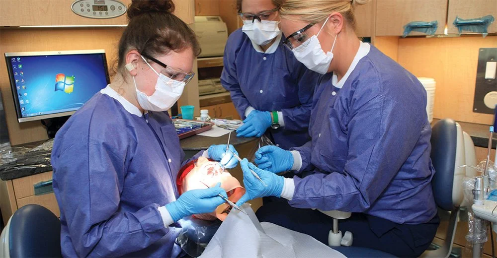 CT State Manchester dental assisting students practicing clinical skills in a training lab.