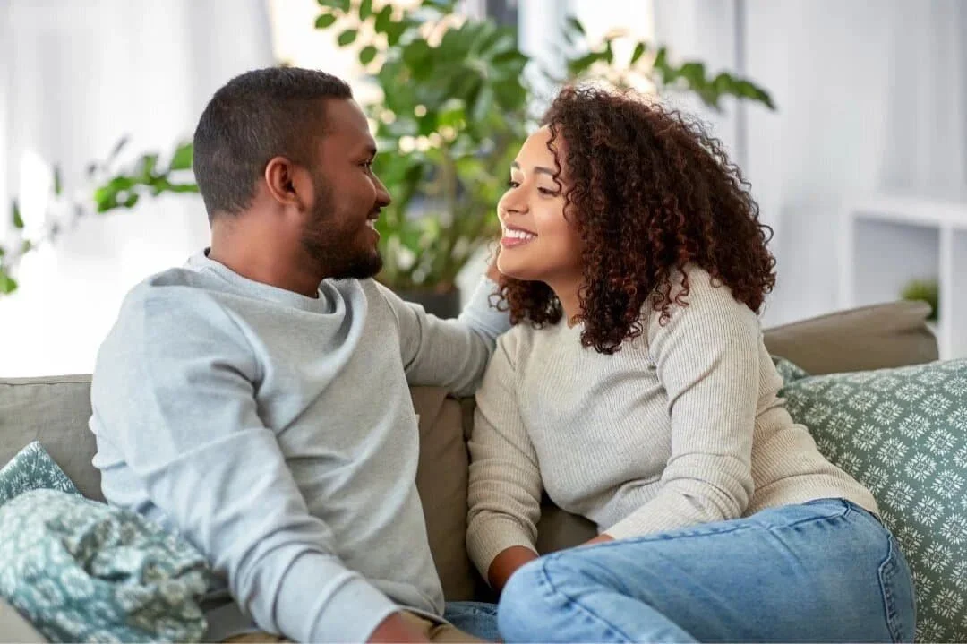 couple on couch looking at each other