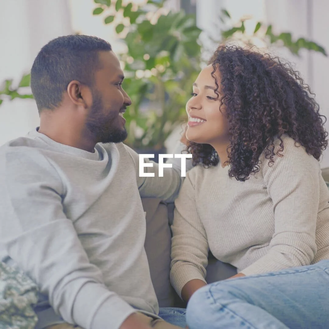 couple smiling on couch with EFT on top of the picture