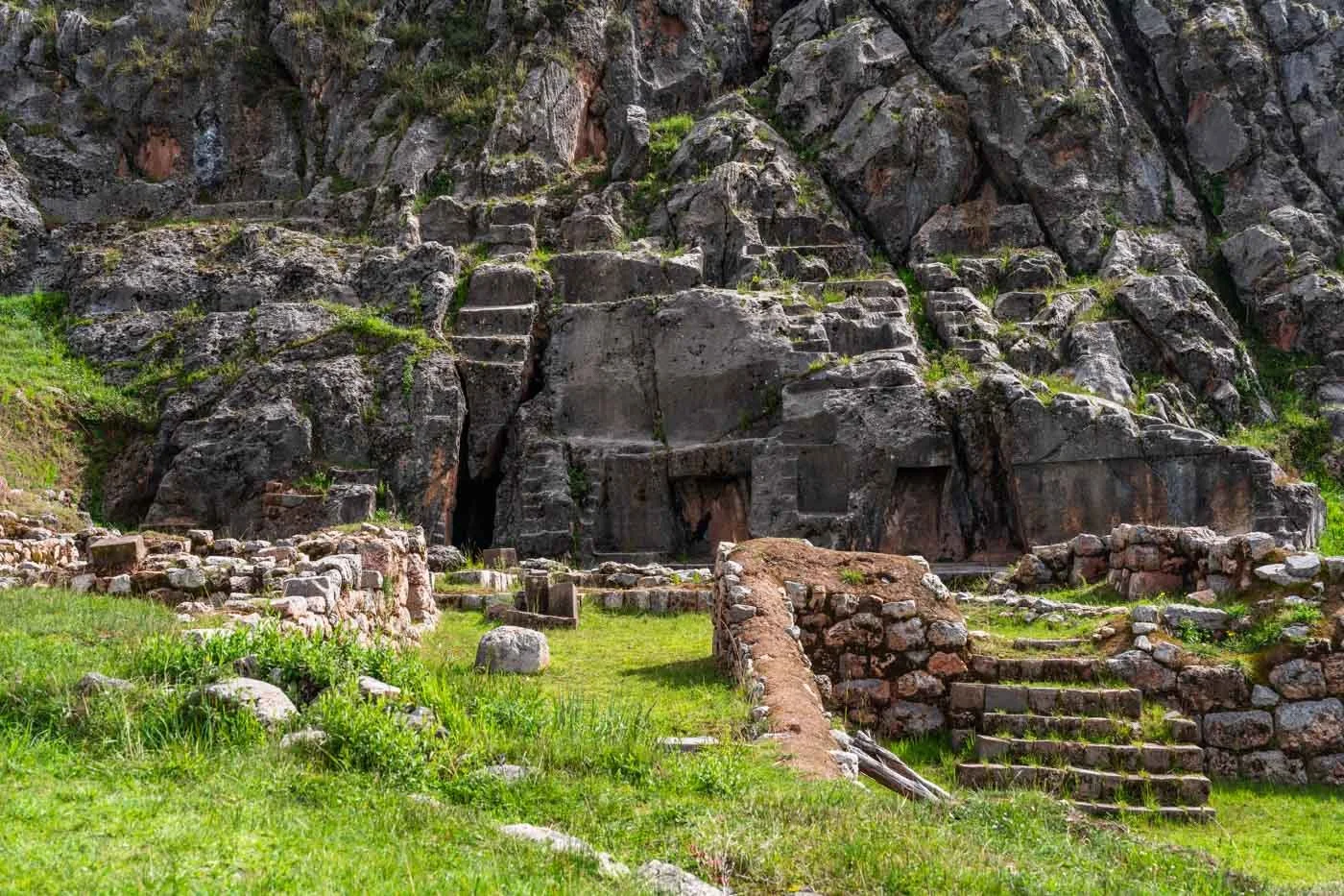 Temple of the Moon ruins near Cusco — ancient stone carvings and cave entrances set into the hillside