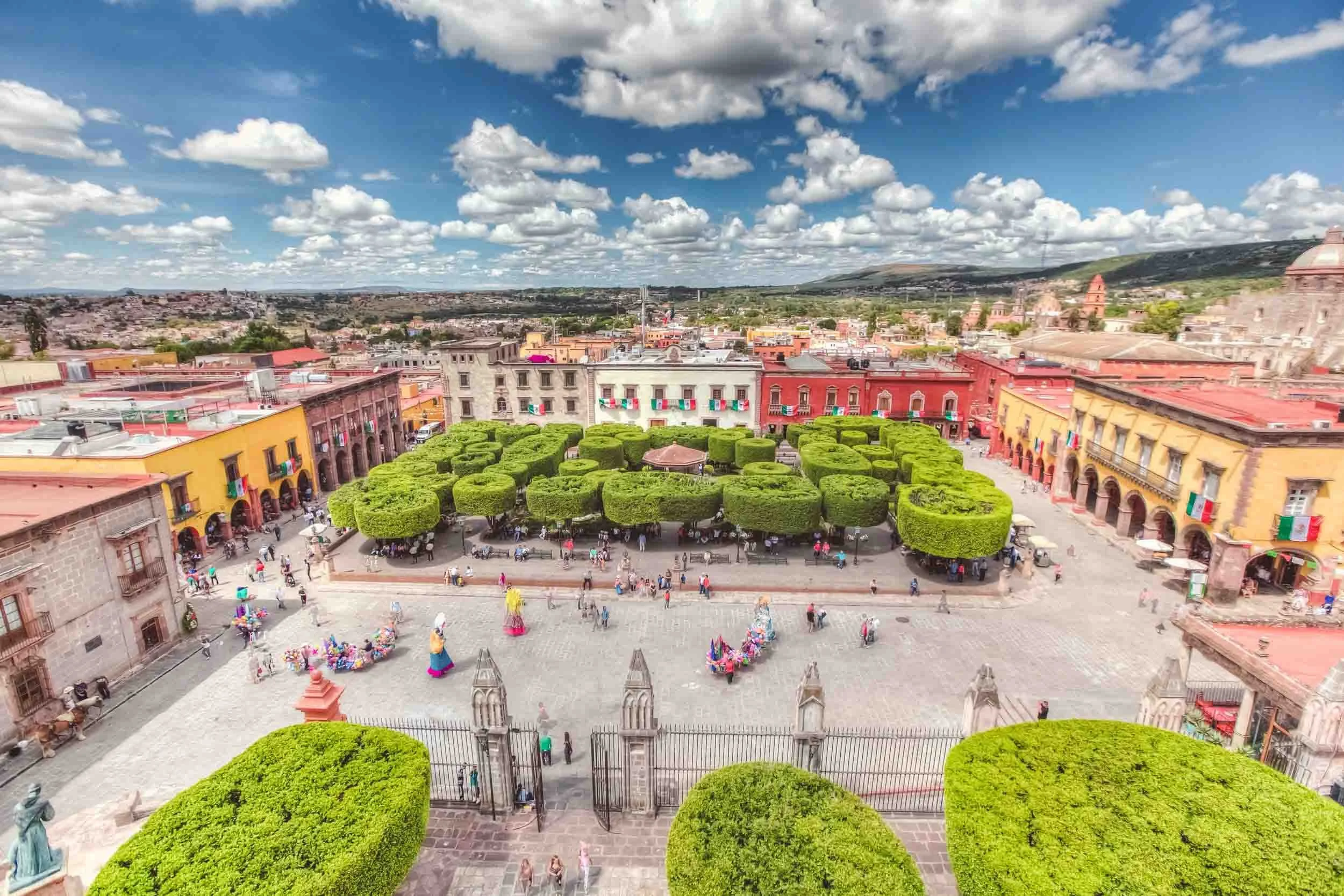 Panoramic view from La Parroquia de San Miguel Arcángel overlooking the Jardín Principal and the colorful historic center of San Miguel de Allende, a UNESCO World Heritage City.