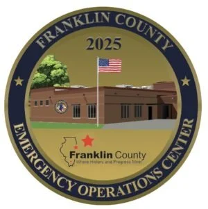 Seal of Franklin County Emergency Operations Center with an American flag, a building, a map outline of Texas with a star, and trees.