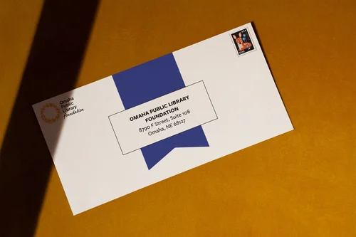 Envelope with a blue ribbon graphic, on orange