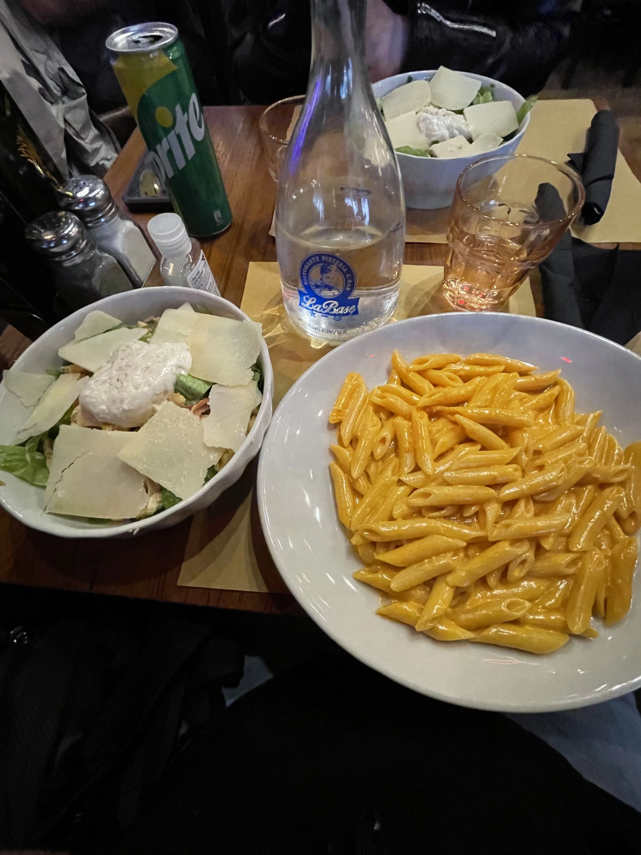 chicken cesar salad and penne vodka at at tourist trap resturant in rome italy